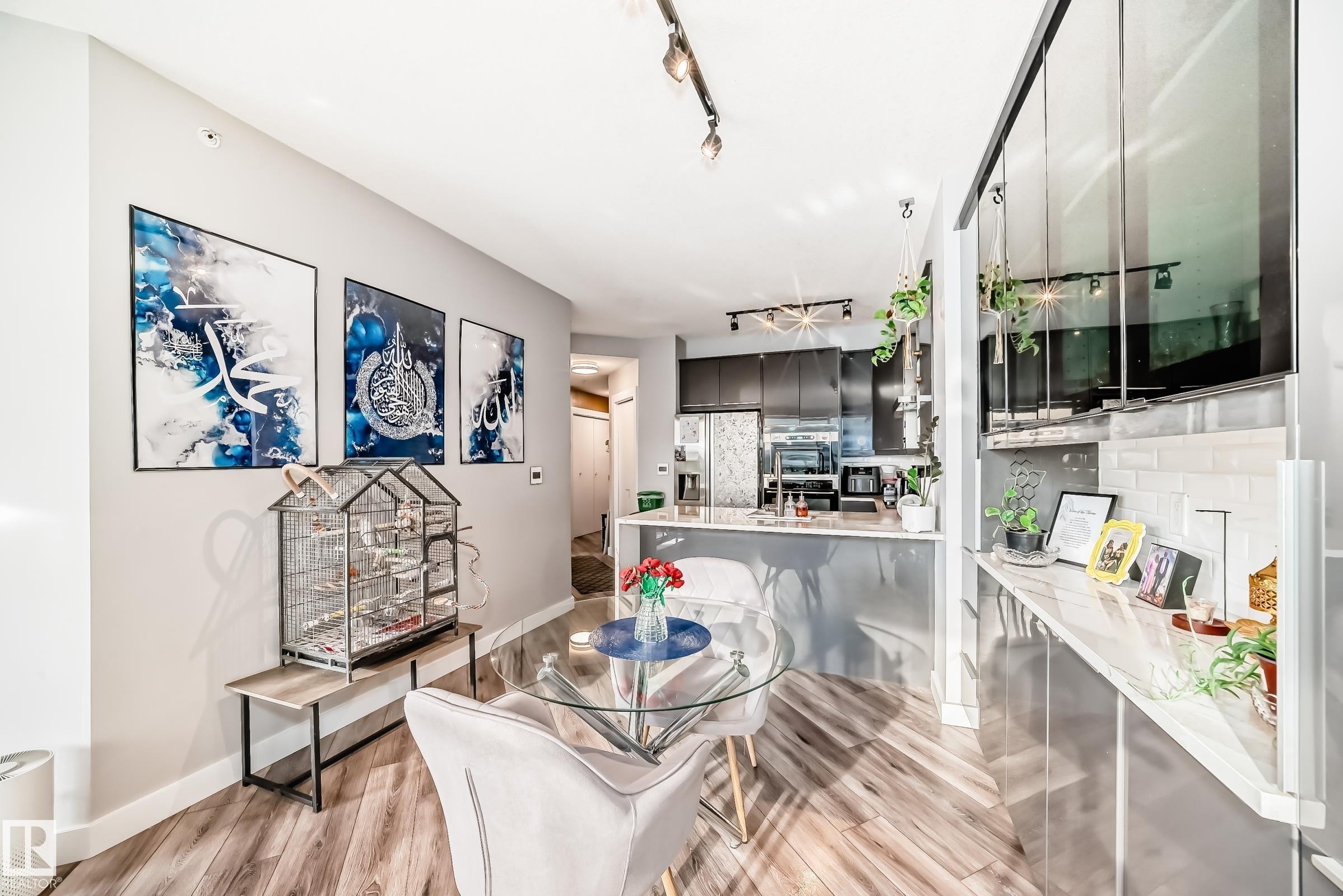 Dining area with track lighting and light wood-style flooring - 2004 10136 104 Street, Edmonton, AB - Indoor