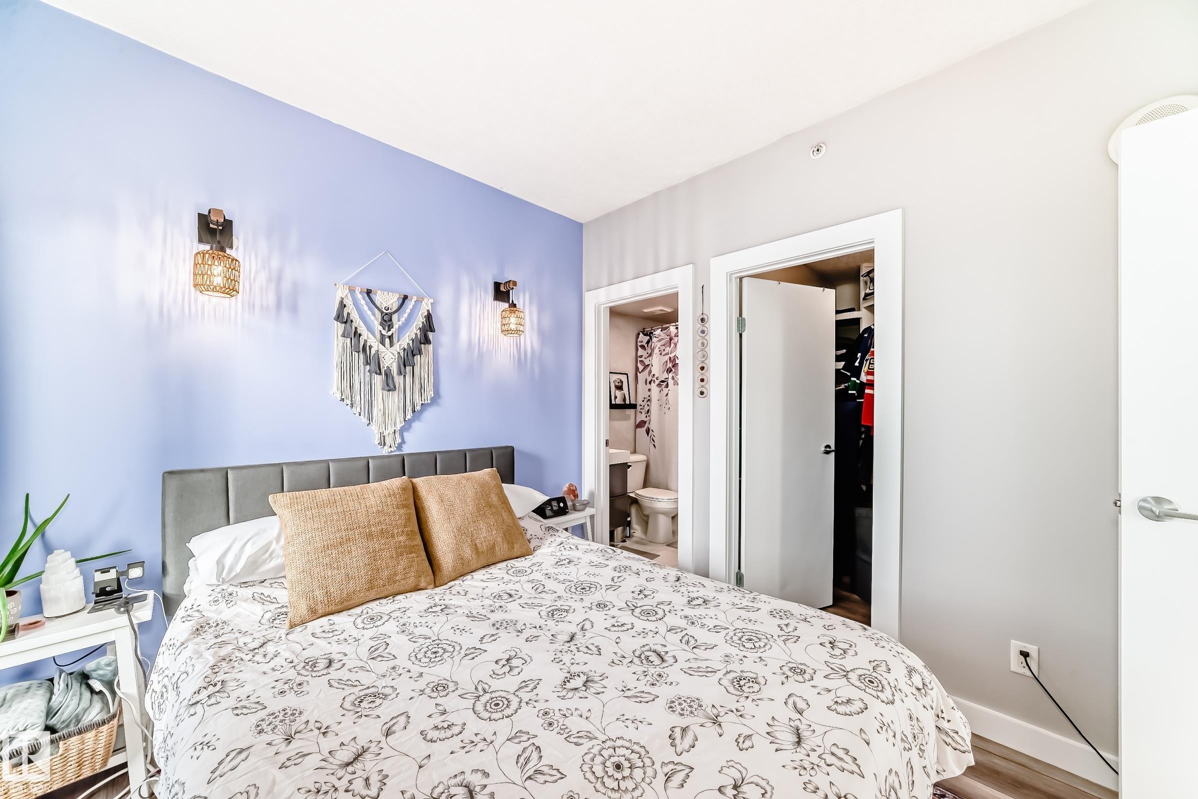Bedroom with a spacious closet, wood finished floors, and connected bathroom - 2004 10136 104 Street, Edmonton, AB - Indoor Photo Showing Bedroom