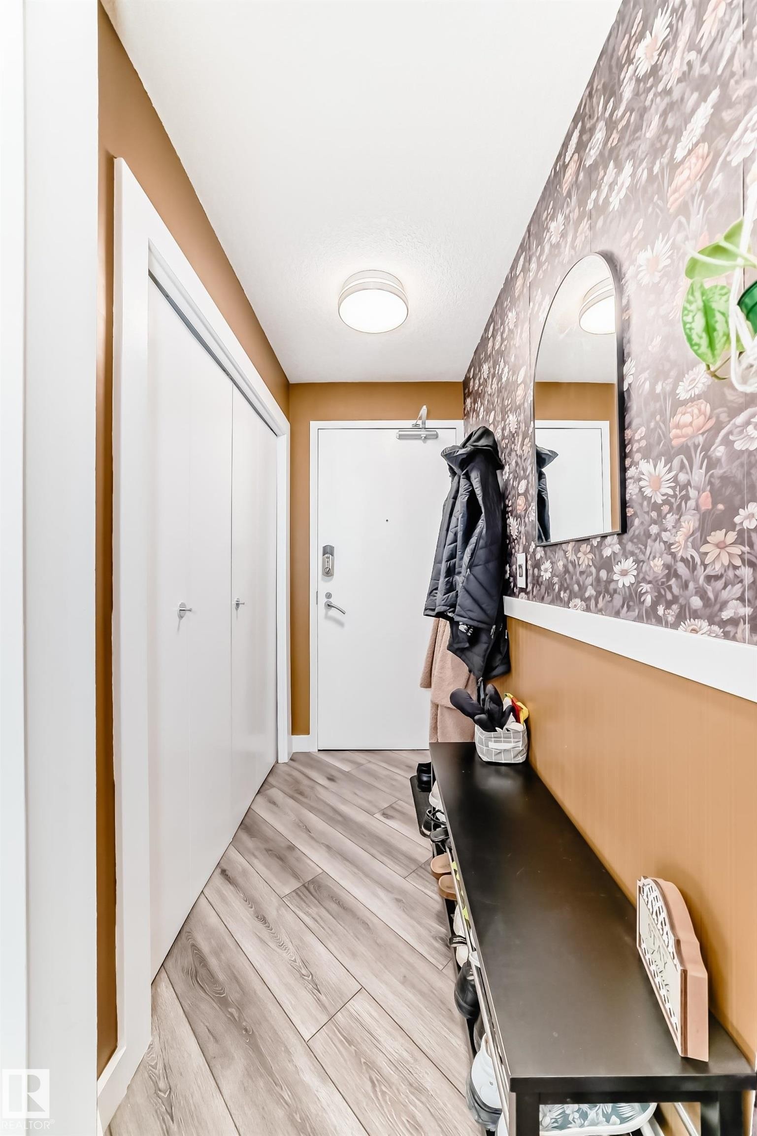 Doorway to outside featuring wood finished floors, wallpapered walls, and a baseboard radiator - 2004 10136 104 Street, Edmonton, AB - Indoor Photo Showing Other Room
