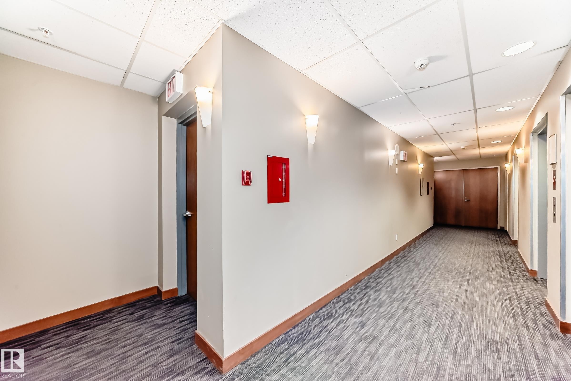 Corridor with a drop ceiling and dark carpet - 2004 10136 104 Street, Edmonton, AB - Indoor Photo Showing Other Room