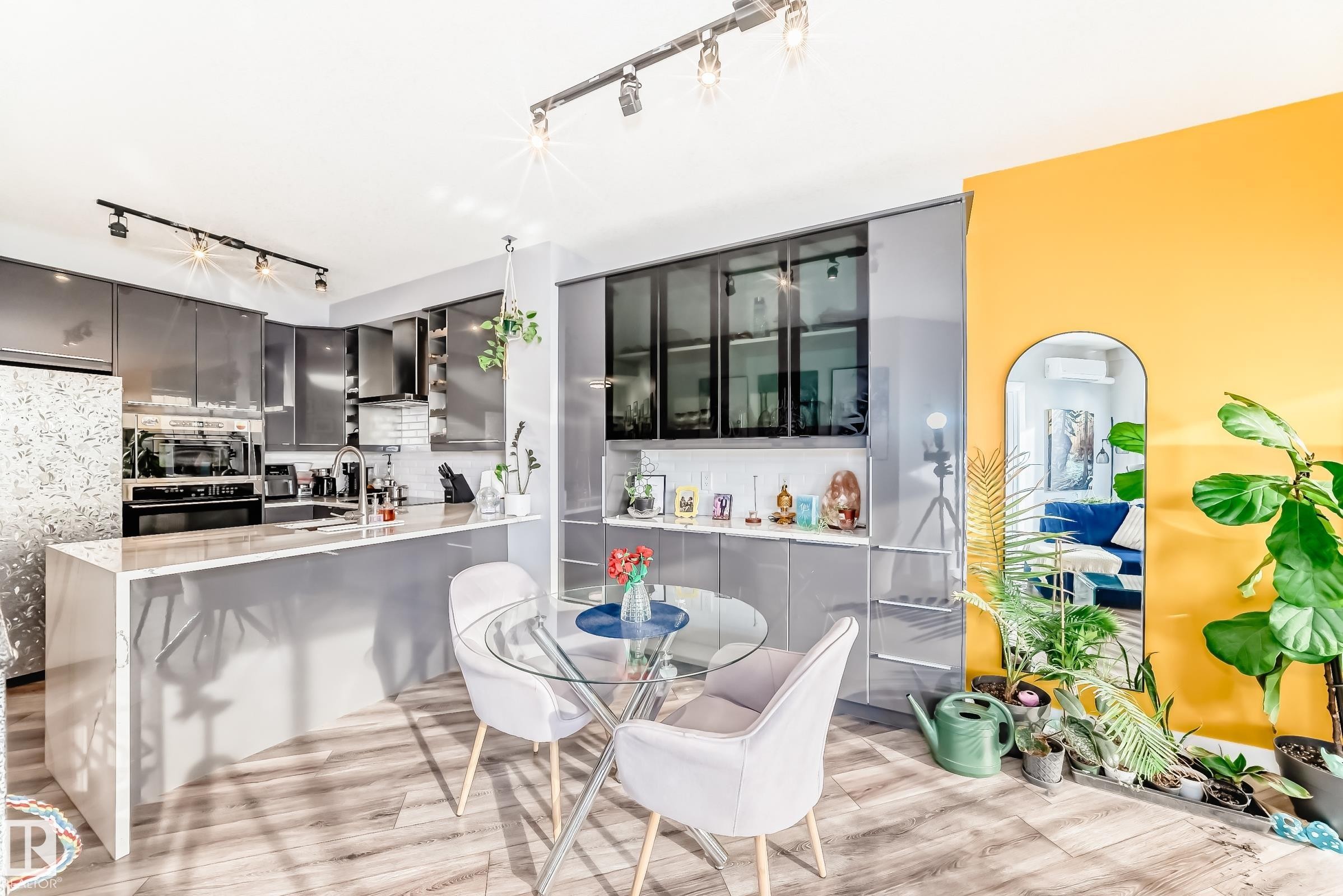 Dining room featuring rail lighting and light wood finished floors - 2004 10136 104 Street, Edmonton, AB - Indoor Photo Showing Dining Room