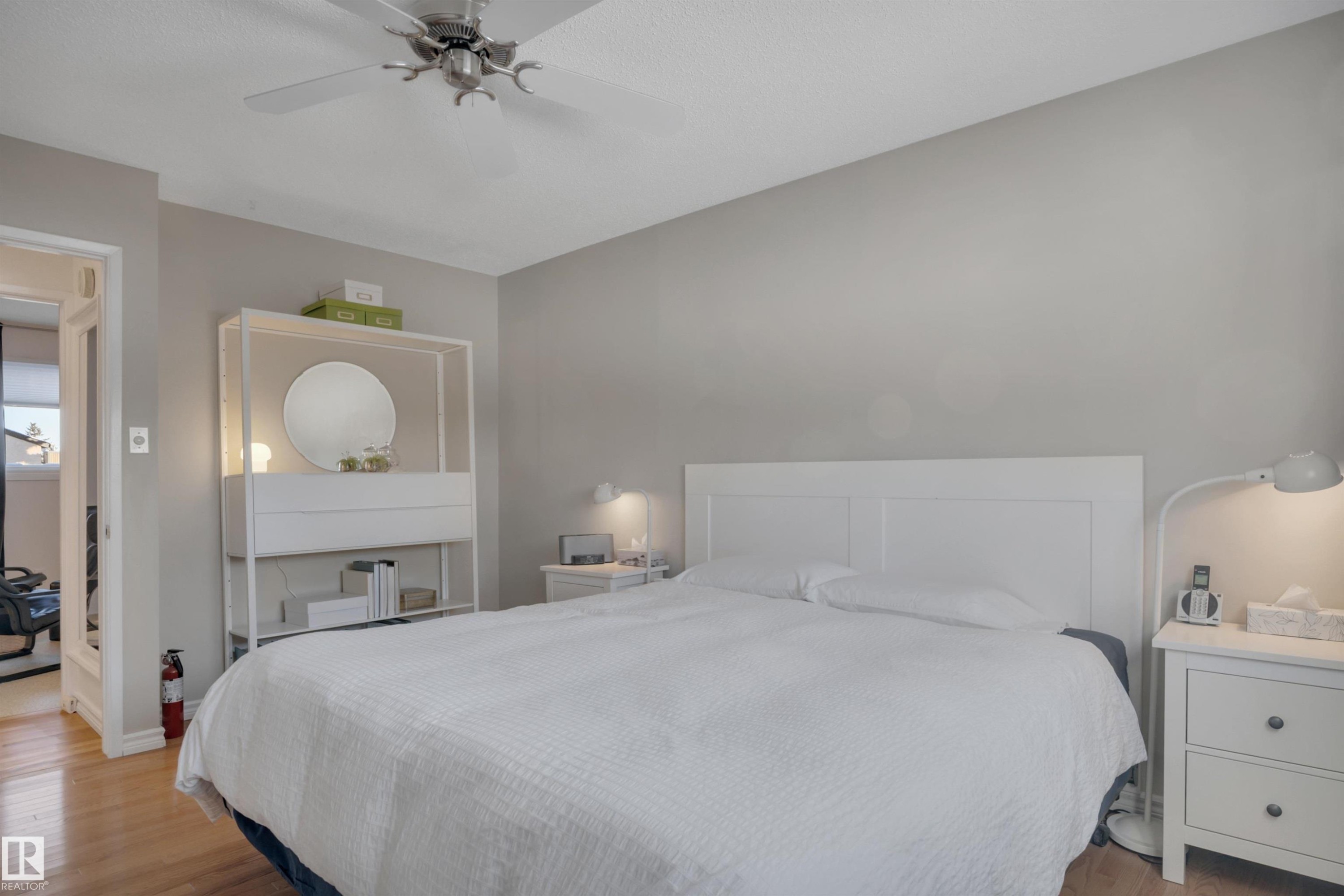 Bedroom featuring light wood-style floors and a ceiling fan - 7075 32 Avenue, Edmonton, AB - Indoor Photo Showing Bedroom