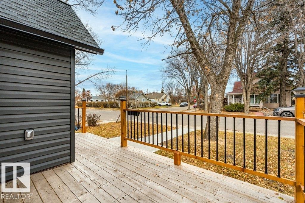 Wooden deck featuring a residential view - 4713 48 Avenue, Wetaskiwin, AB - Outdoor With Deck Patio Veranda