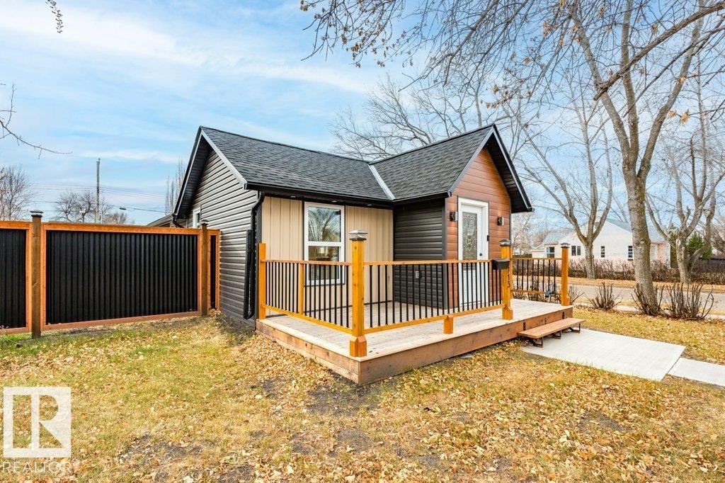 View of side of property featuring a wooden deck and a shingled roof - 4713 48 Avenue, Wetaskiwin, AB - Outdoor With Deck Patio Veranda