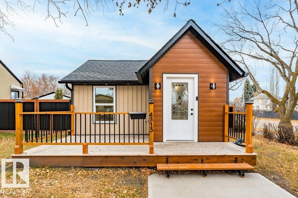 View of front facade featuring a wooden deck and roof with shingles - 4713 48 Avenue, Wetaskiwin, AB - Outdoor With Deck Patio Veranda