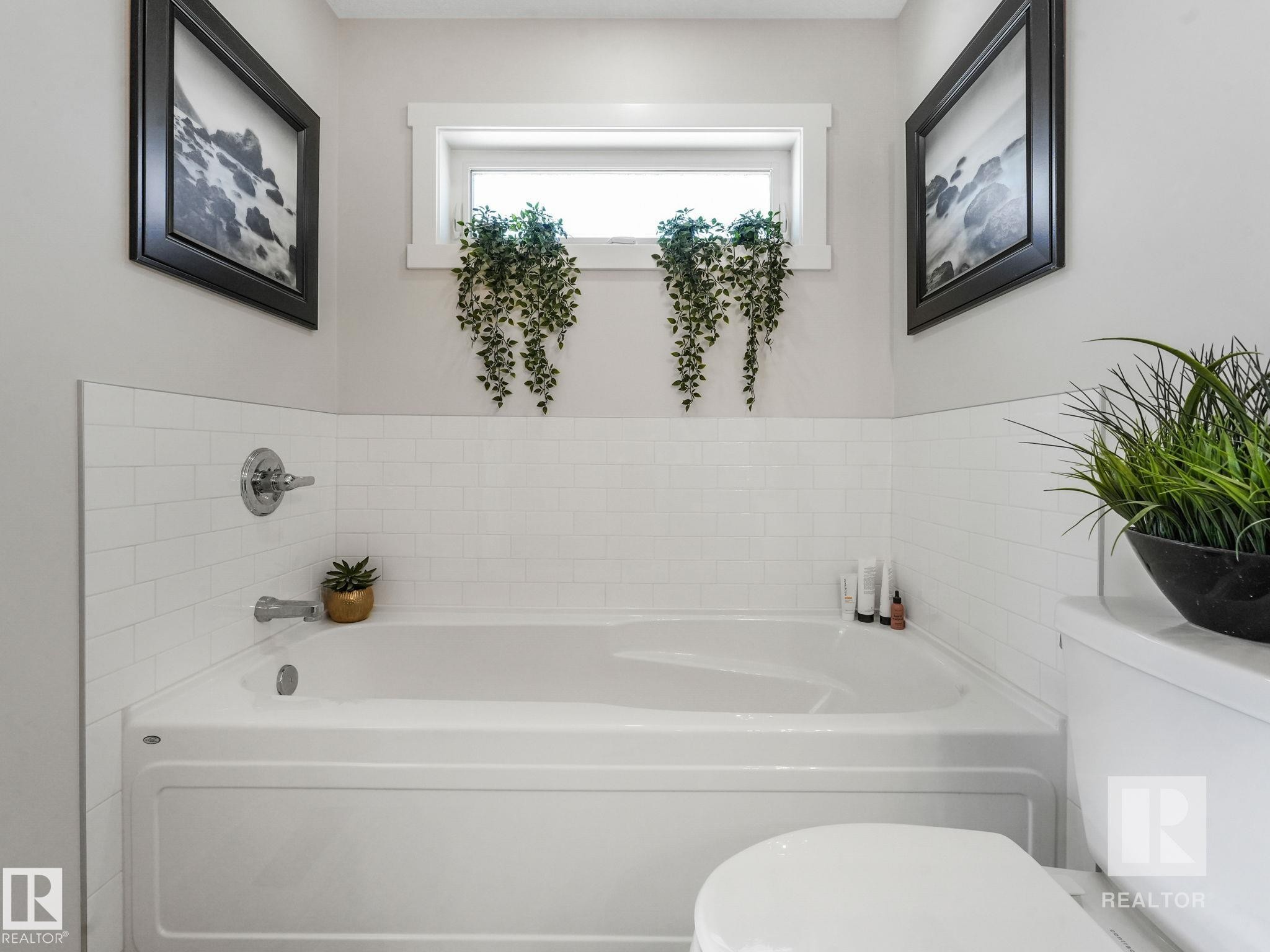 Bathroom with toilet and a garden tub - 209 55101 Ste. Anne Trail, Rural Lac Ste. Anne County, AB - Indoor Photo Showing Bathroom