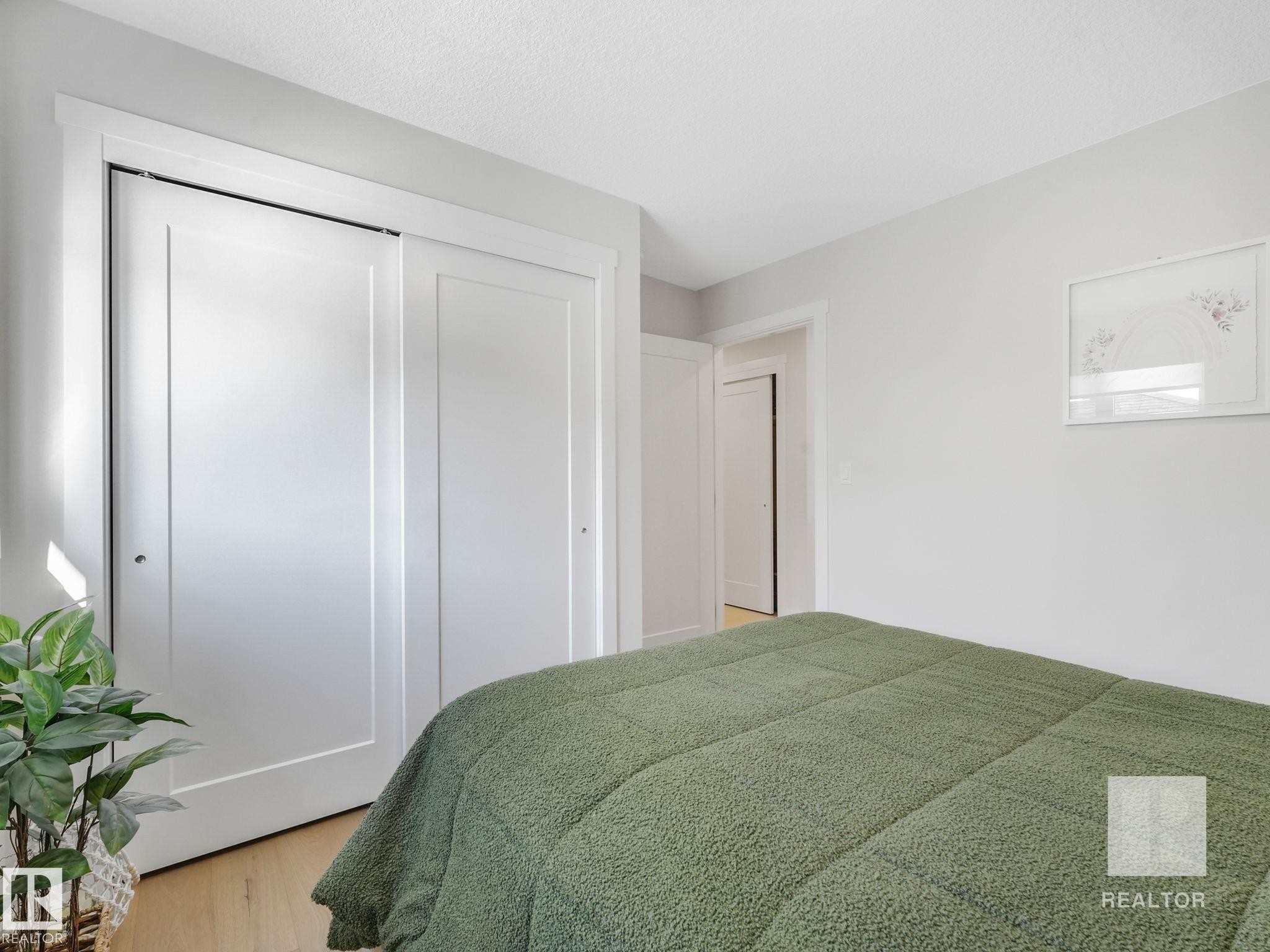 Bedroom featuring a closet and light wood-style flooring - 209 55101 Ste. Anne Trail, Rural Lac Ste. Anne County, AB - Indoor Photo Showing Bedroom