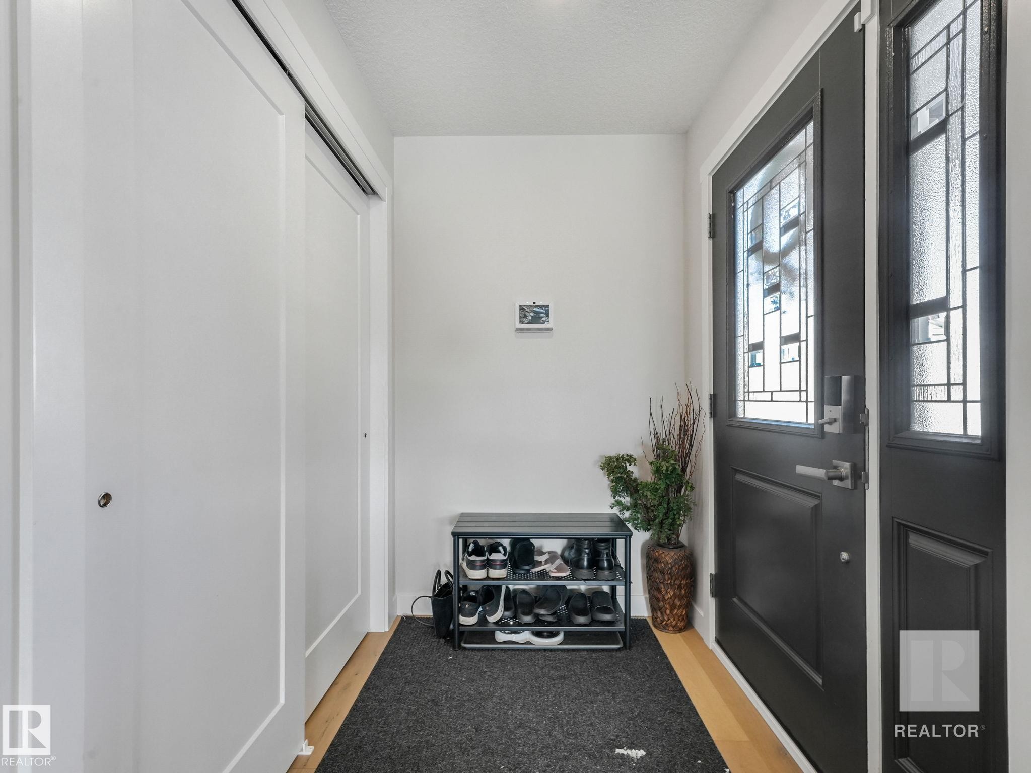 Entrance foyer featuring a textured ceiling - 209 55101 Ste. Anne Trail, Rural Lac Ste. Anne County, AB - Indoor Photo Showing Other Room