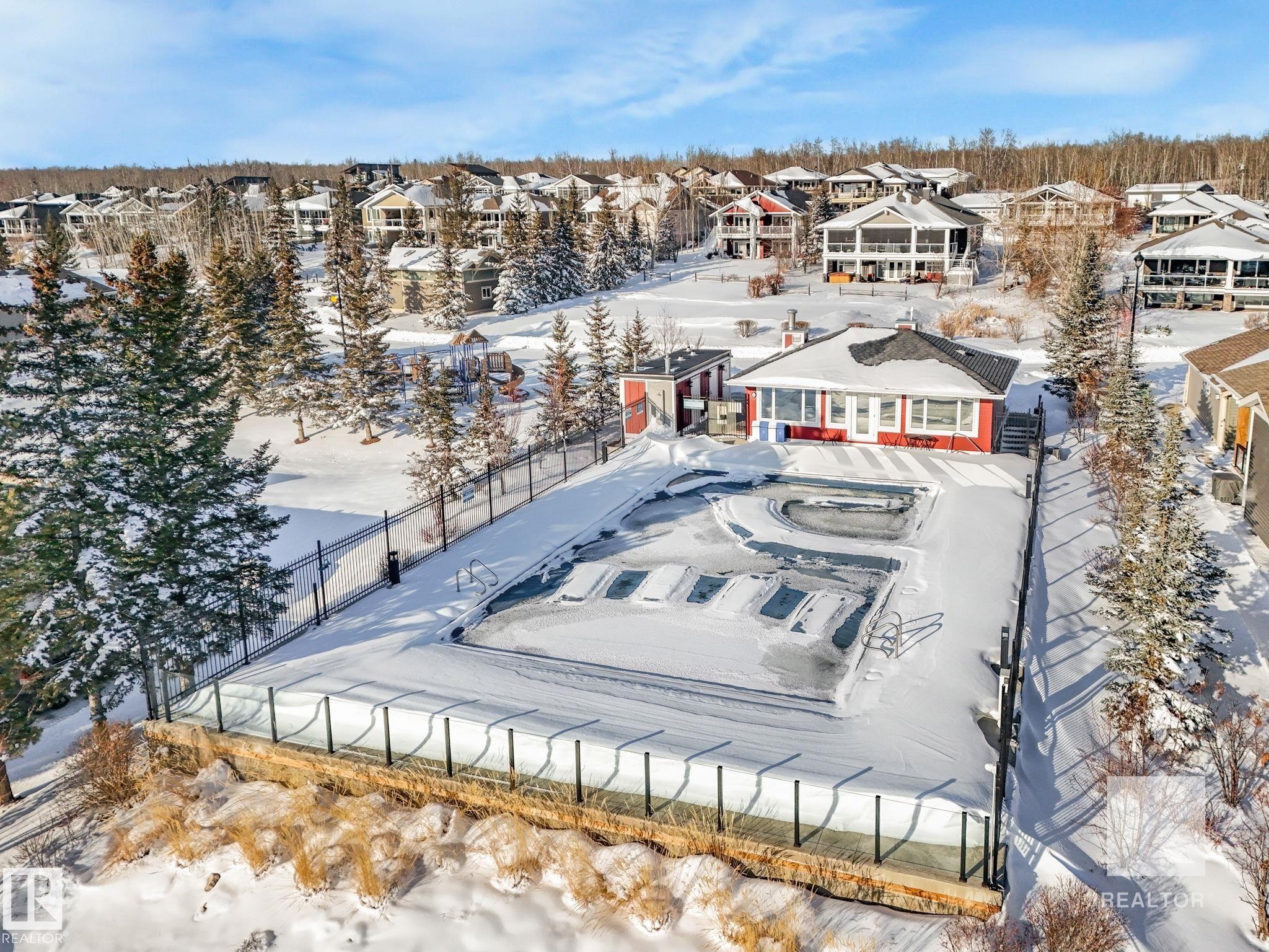 Snowy aerial view with a residential view - 209 55101 Ste. Anne Trail, Rural Lac Ste. Anne County, AB - Outdoor With View