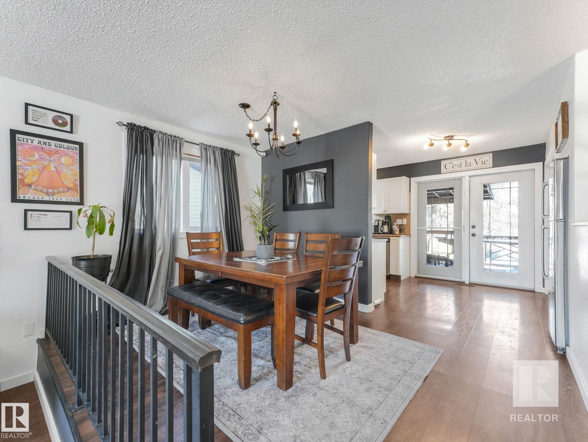 Dining room featuring hardwood / wood-style flooring, a textured ceiling, and suspended lighting - 4504 48 Avenue, Onoway, AB - Indoor Photo Showing Dining Room