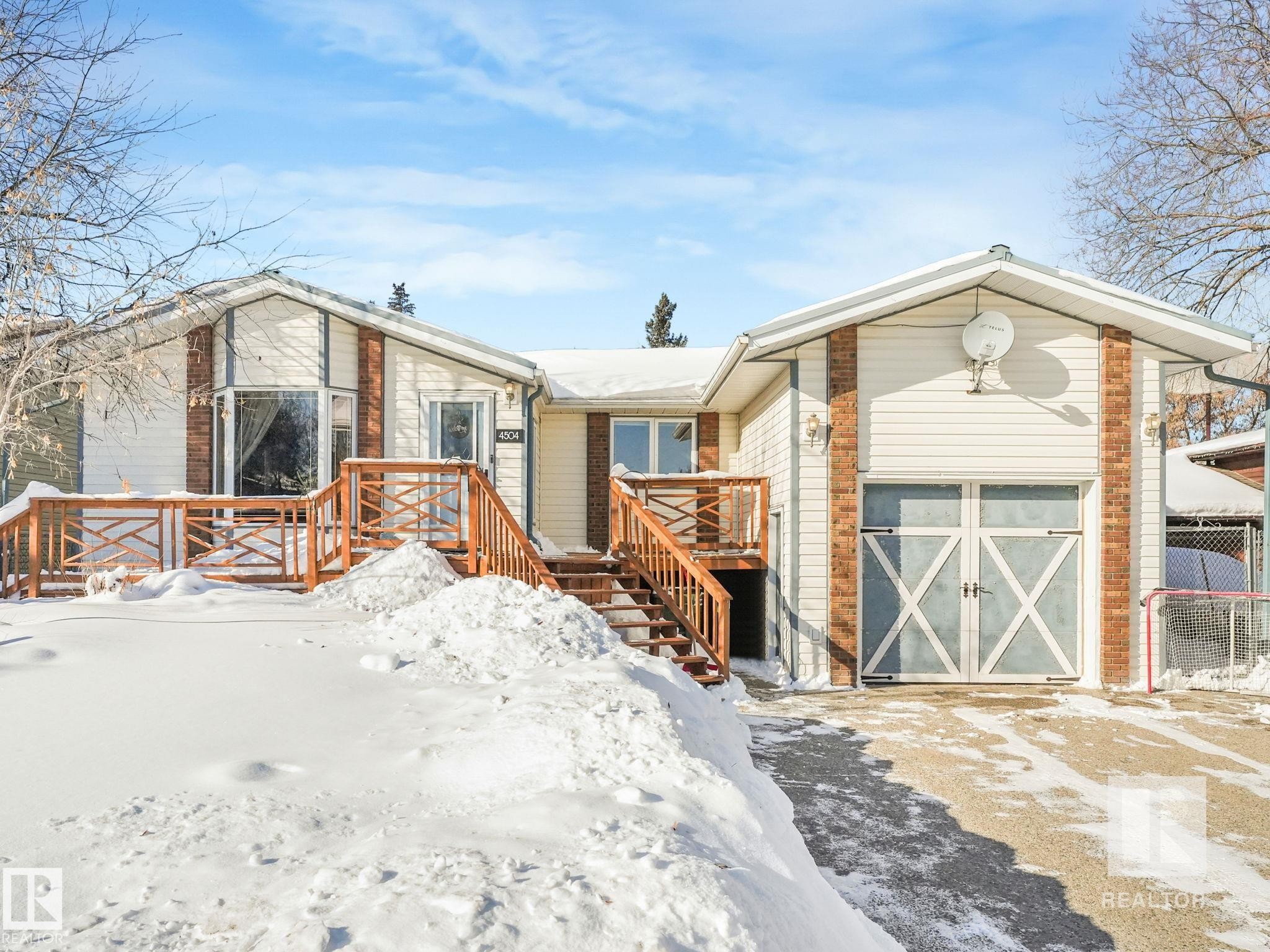 View of front of property featuring an outdoor structure and a deck - 4504 48 Avenue, Onoway, AB - Outdoor