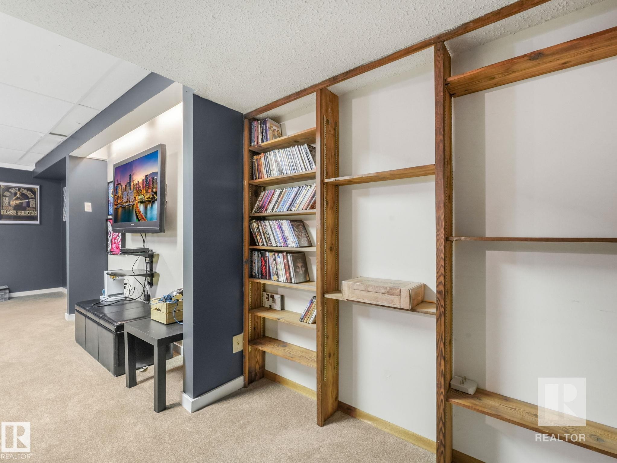 Hallway with light colored carpet and a drop ceiling - 4504 48 Avenue, Onoway, AB - Indoor