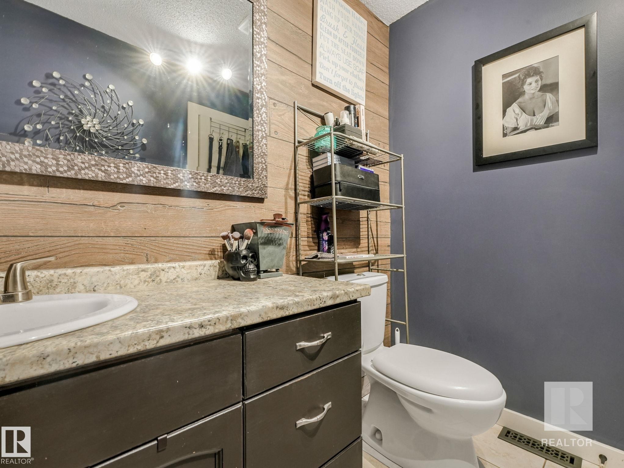 Bathroom featuring vanity and wood walls - 4504 48 Avenue, Onoway, AB - Indoor Photo Showing Bathroom
