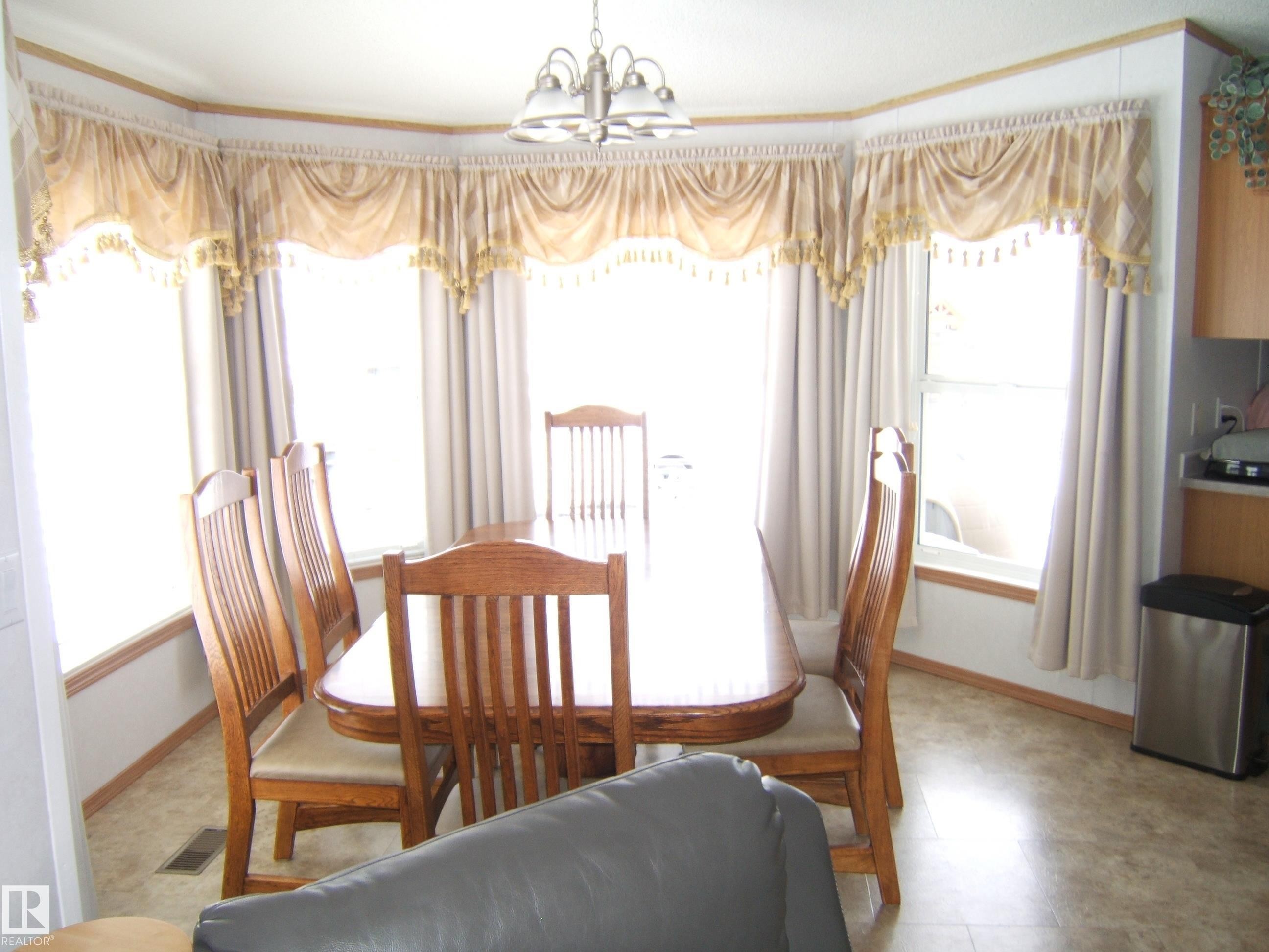 Dining space with hanging lights and baseboards - 125076 Twp Rd 540, Rural Two Hills County, AB - Indoor Photo Showing Dining Room