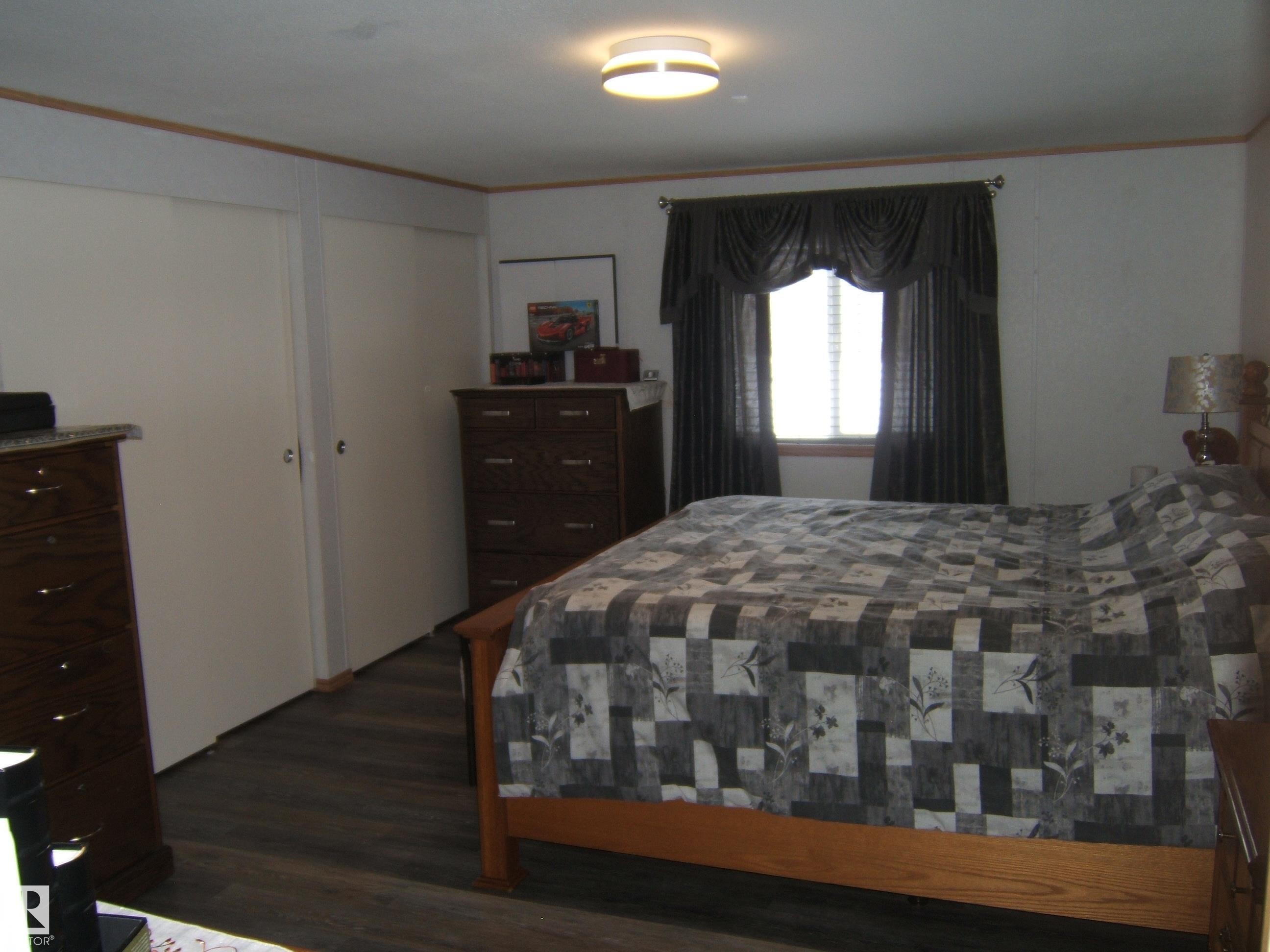Bedroom featuring ornamental molding and dark wood-style floors - 125076 Twp Rd 540, Rural Two Hills County, AB - Indoor Photo Showing Bedroom