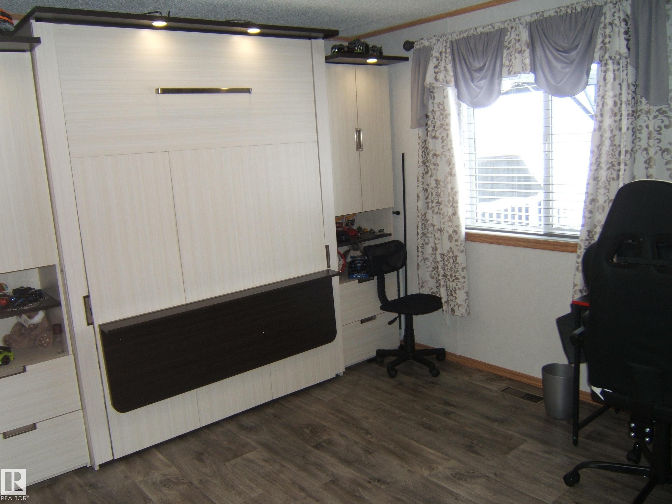 Misc room with dark wood-style flooring and crown molding - 125076 Twp Rd 540, Rural Two Hills County, AB - Indoor Photo Showing Other Room