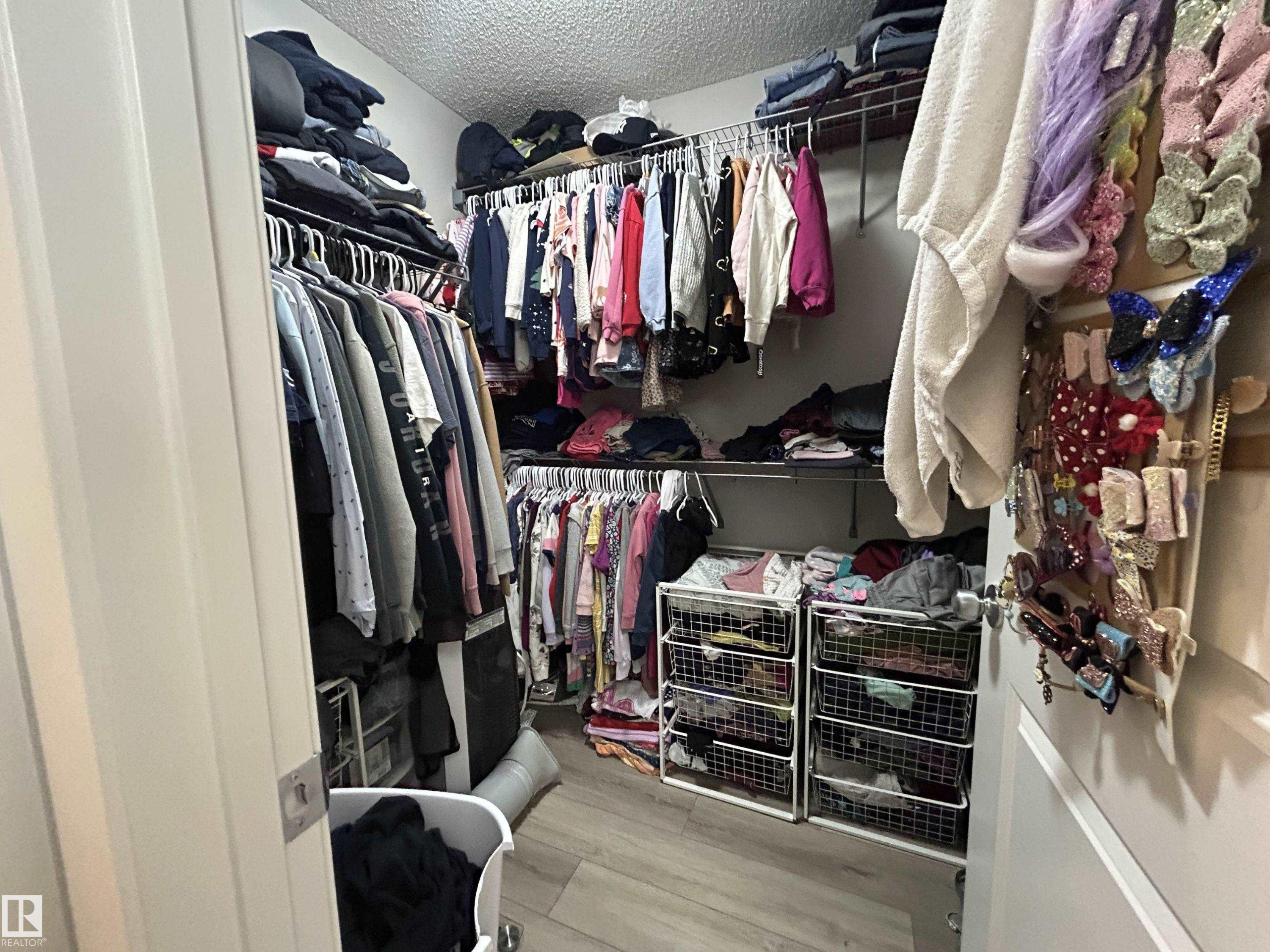 Walk in closet featuring light wood-style floors - 120 1530 Tamarack Boulevard, Edmonton, AB - Indoor With Storage