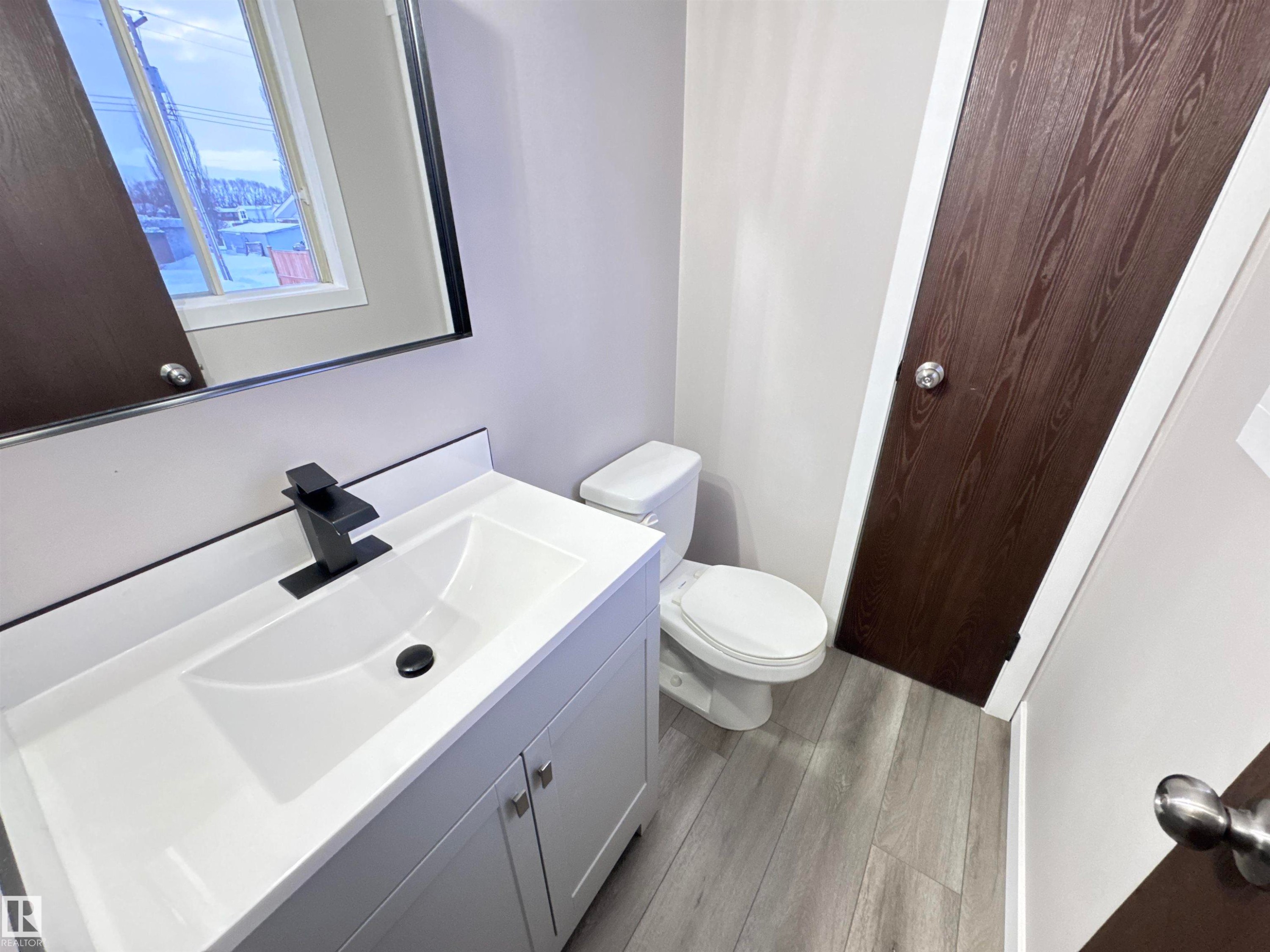 Bathroom featuring vanity and light wood finished floors - 4919 49 Avenue, Vimy, AB - Indoor Photo Showing Bathroom
