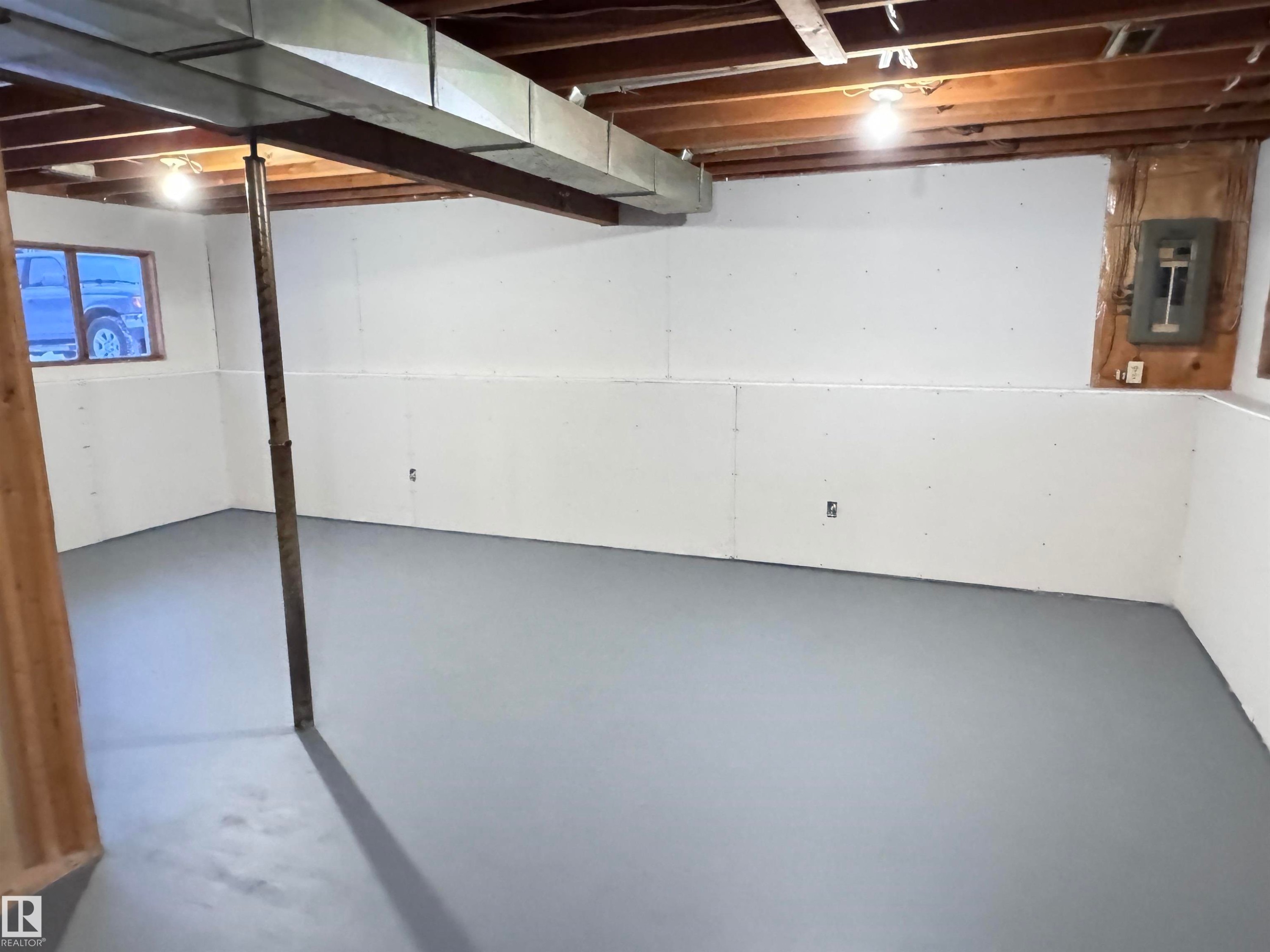 Unfinished basement featuring electric panel - 4919 49 Avenue, Vimy, AB - Indoor Photo Showing Basement