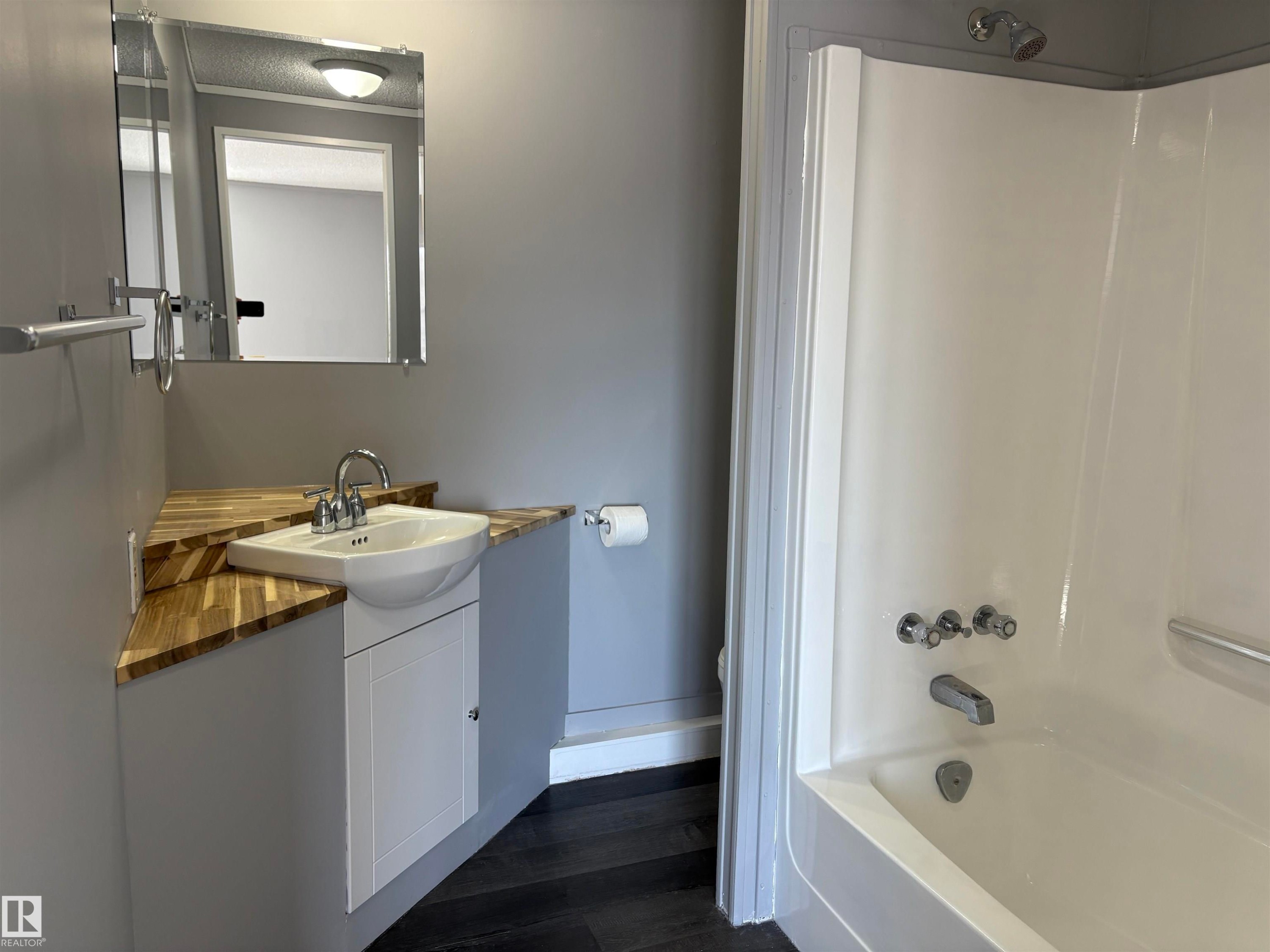Full bathroom featuring vanity, tub / shower combination, and dark wood-style floors - 8 Evergreen Park Drive, Edmonton, AB - Indoor Photo Showing Bathroom