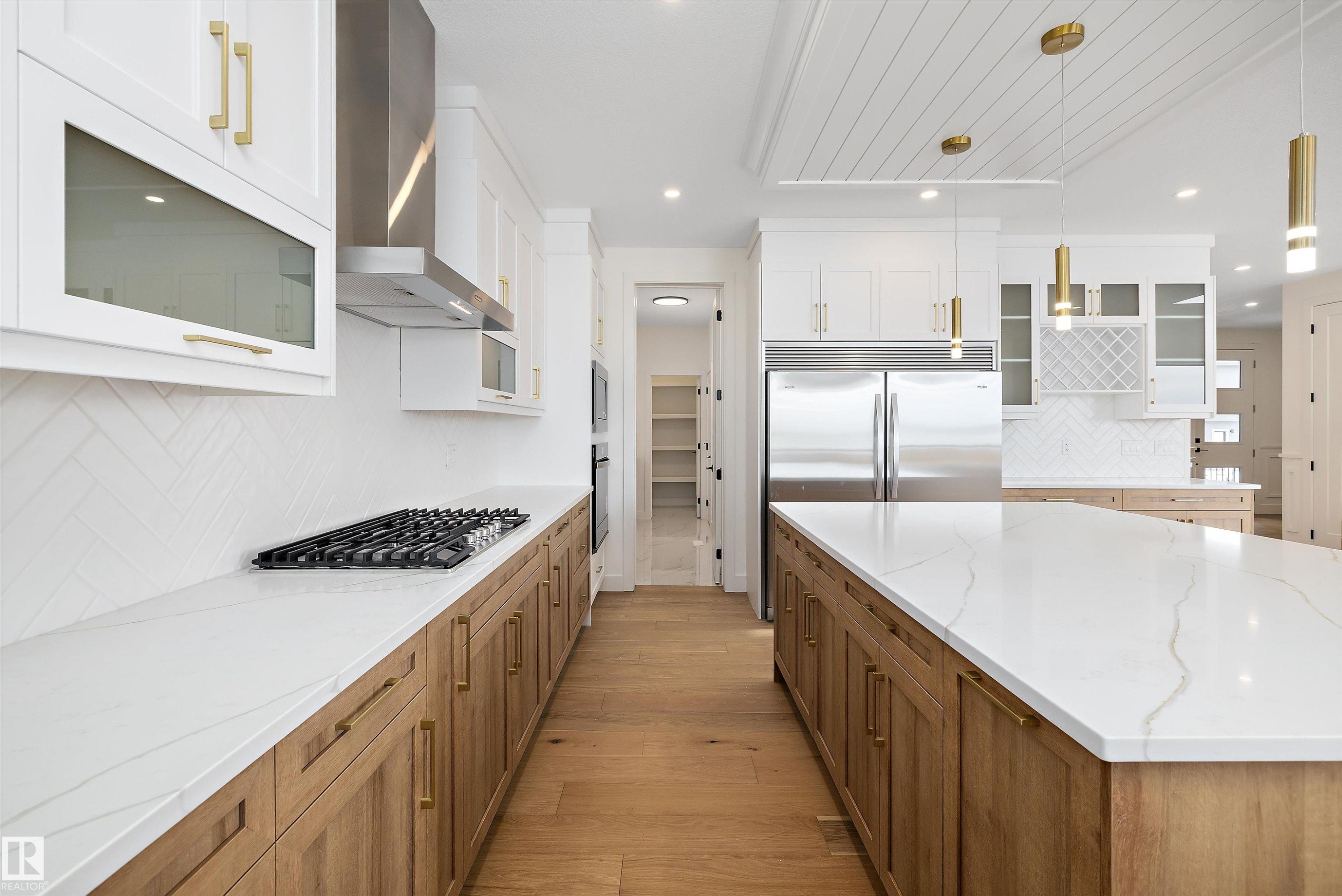 Dual tone kitchen with glass fronted cabinets, decorative backsplash, light stone counters, and dual tone cabinetry - 6871 Knox Loop Sw, Edmonton, AB - Indoor Photo Showing Kitchen With Upgraded Kitchen
