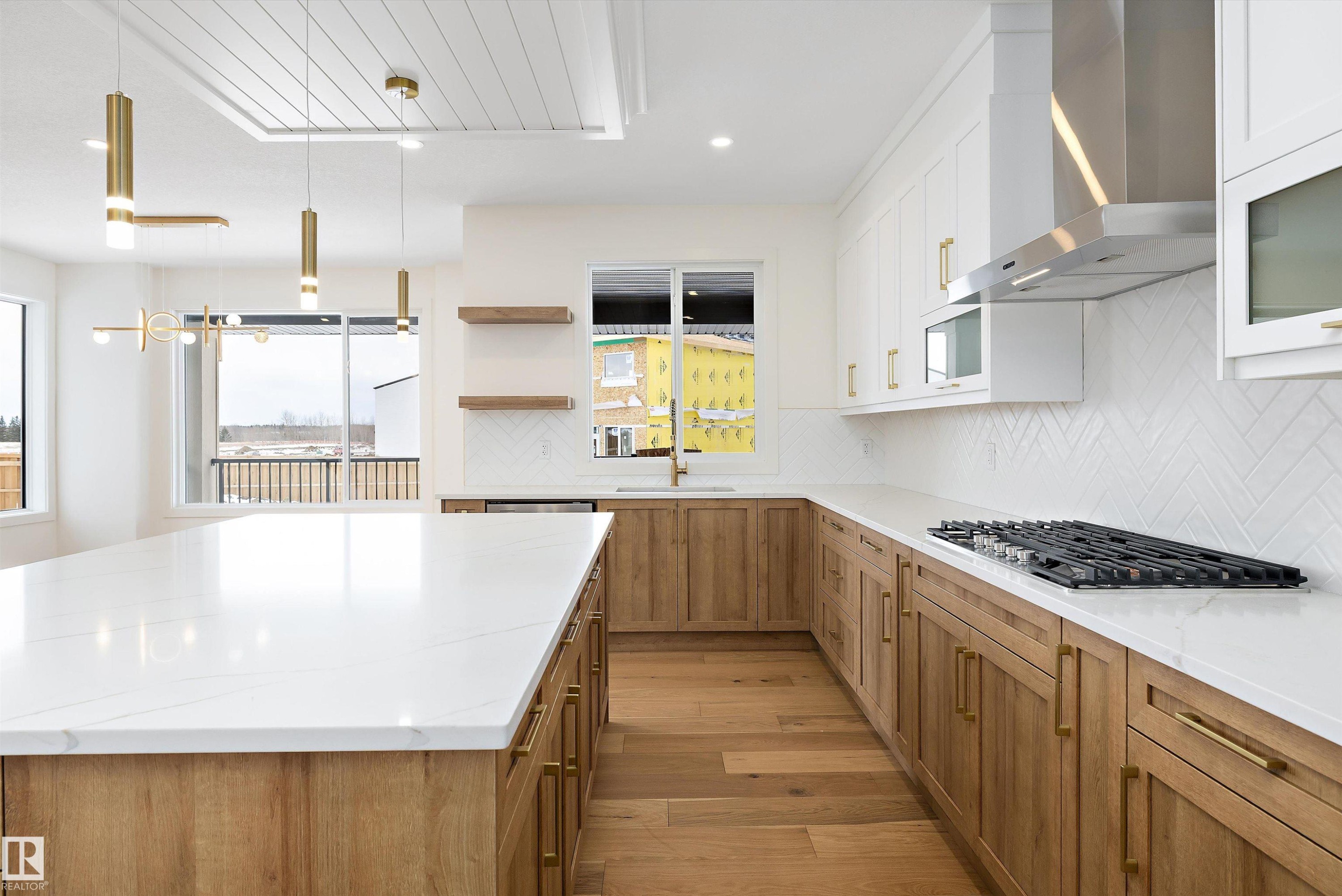 Kitchen featuring open shelves, light wood-type flooring, backsplash, two tone color scheme, and decorative light fixtures - 6871 Knox Loop Sw, Edmonton, AB - Indoor Photo Showing Kitchen With Upgraded Kitchen