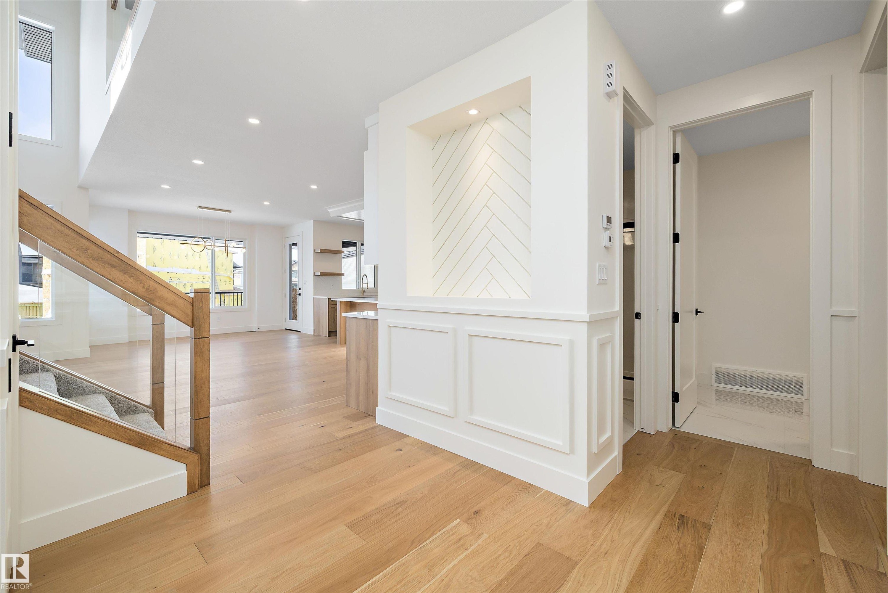Hall with light wood-type flooring, recessed lighting, and a decorative wall - 6871 Knox Loop Sw, Edmonton, AB - Indoor Photo Showing Other Room
