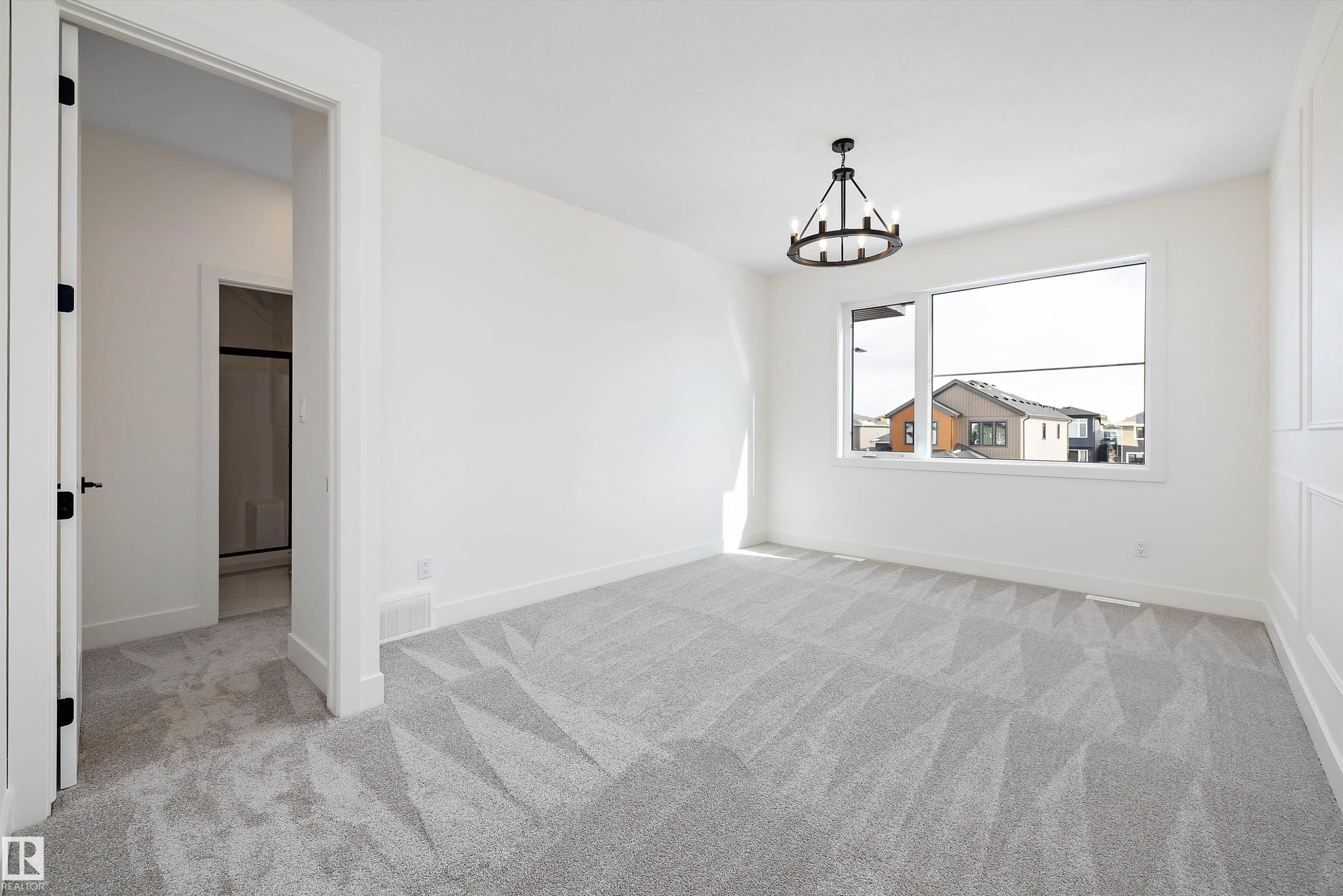 Spare room with light colored carpet and hanging lights - 6871 Knox Loop Sw, Edmonton, AB - Indoor