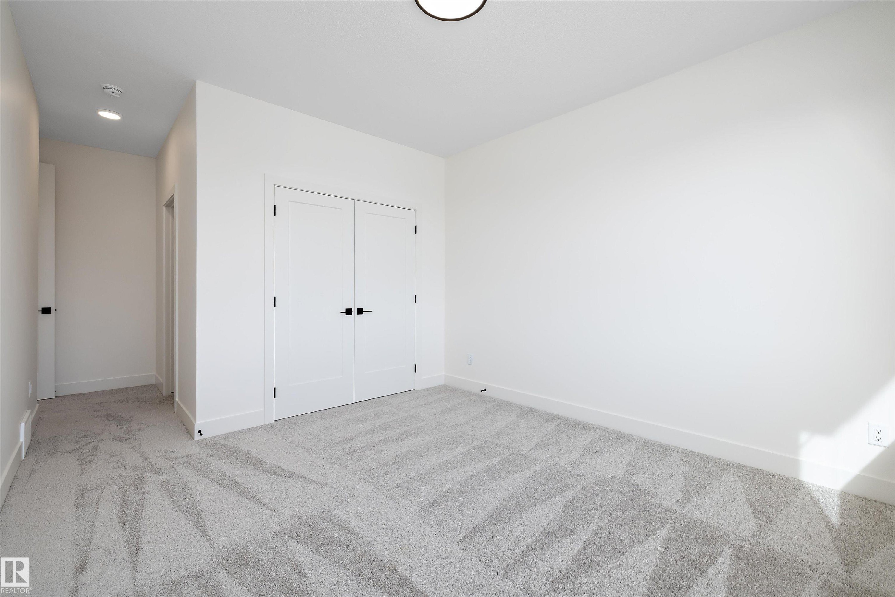 Unfurnished bedroom featuring light carpet, a closet, and recessed lighting - 6871 Knox Loop Sw, Edmonton, AB - Indoor Photo Showing Other Room