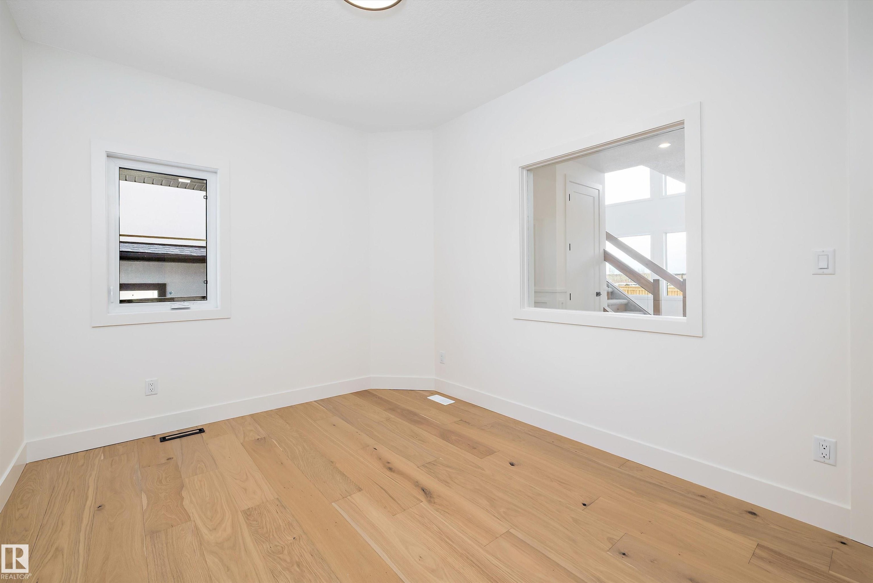 Empty room with baseboards and light wood finished floors - 6871 Knox Loop Sw, Edmonton, AB - Indoor Photo Showing Other Room