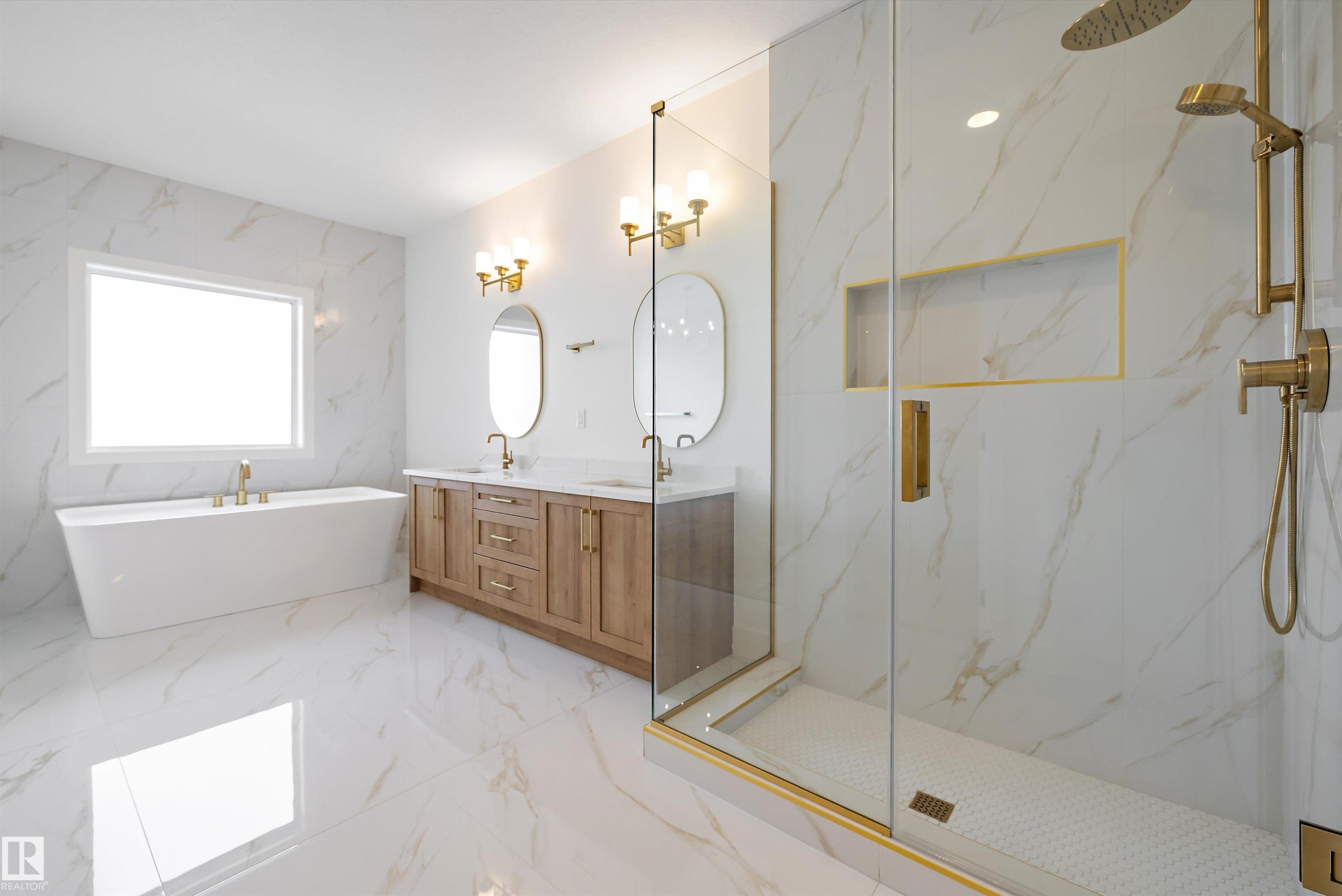 Full bath with double vanity, a marble finish shower, light marble finish floors, stone wall, and a freestanding bath - 6871 Knox Loop Sw, Edmonton, AB - Indoor Photo Showing Bathroom