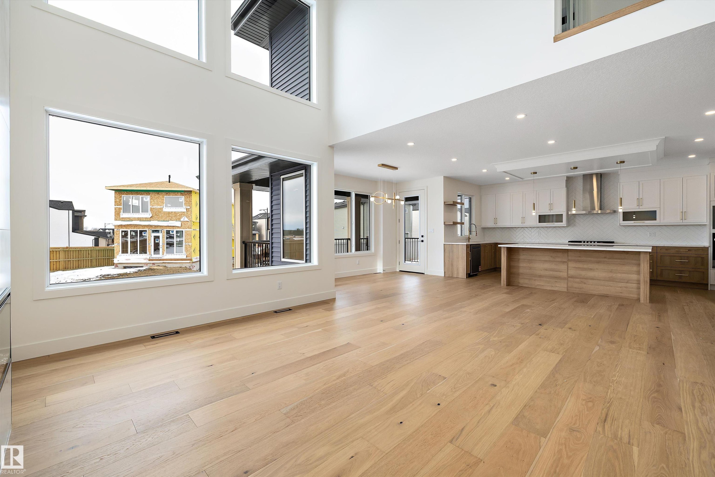 Unfurnished living room with light wood-style flooring, recessed lighting, and a high ceiling - 6871 Knox Loop Sw, Edmonton, AB - Indoor Photo Showing Other Room