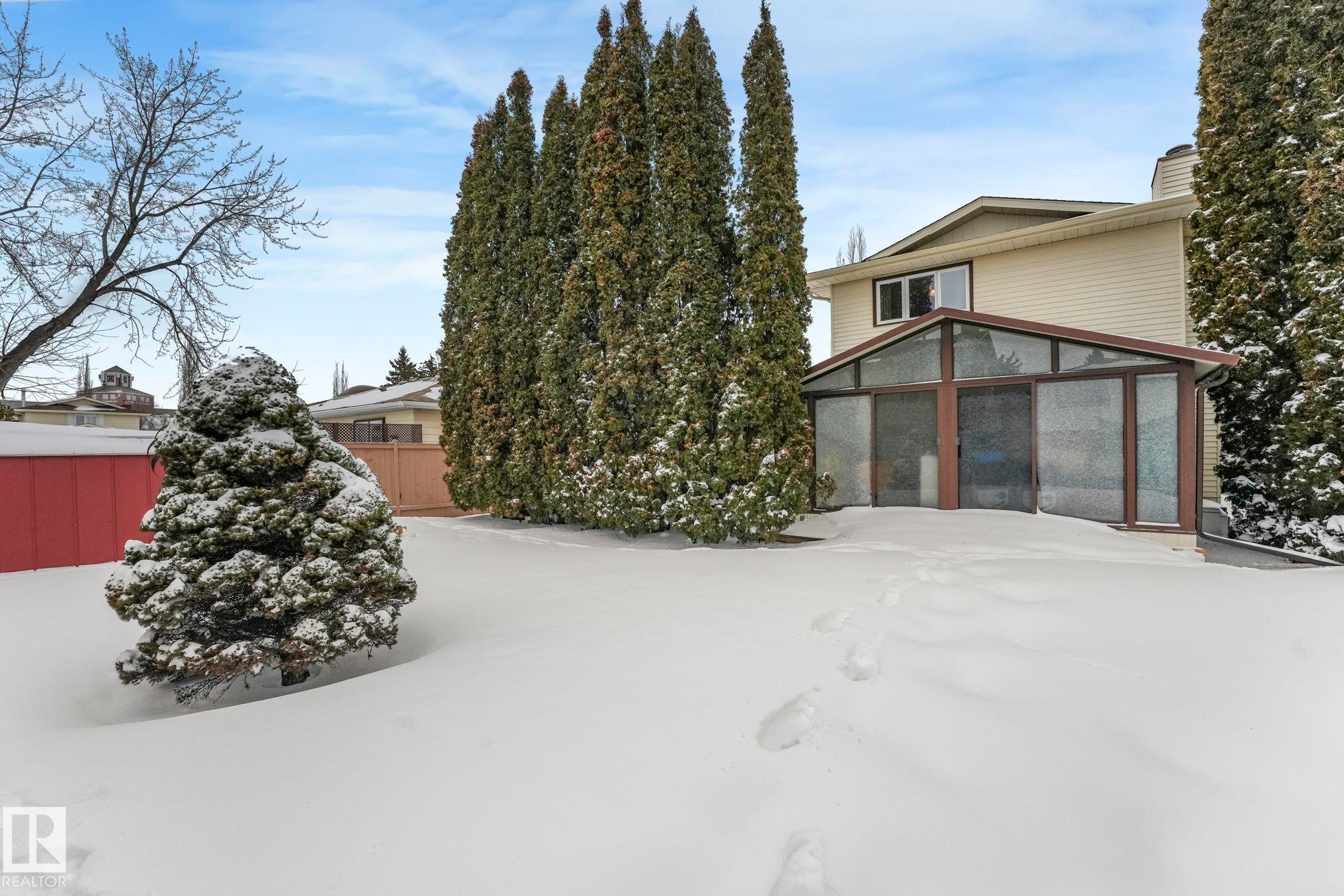 View of front of house with a sunroom and a chimney - 15909 112 B Street Nw, Edmonton, AB - Outdoor