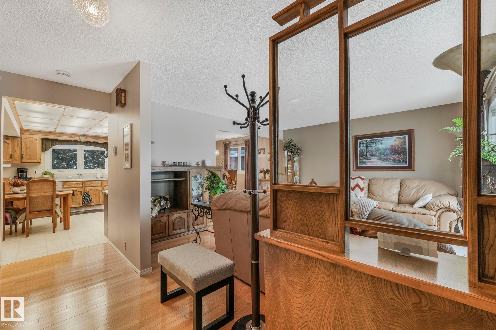 Corridor featuring a textured ceiling and light wood-style floors - 15909 112 B Street Nw, Edmonton, AB - Indoor