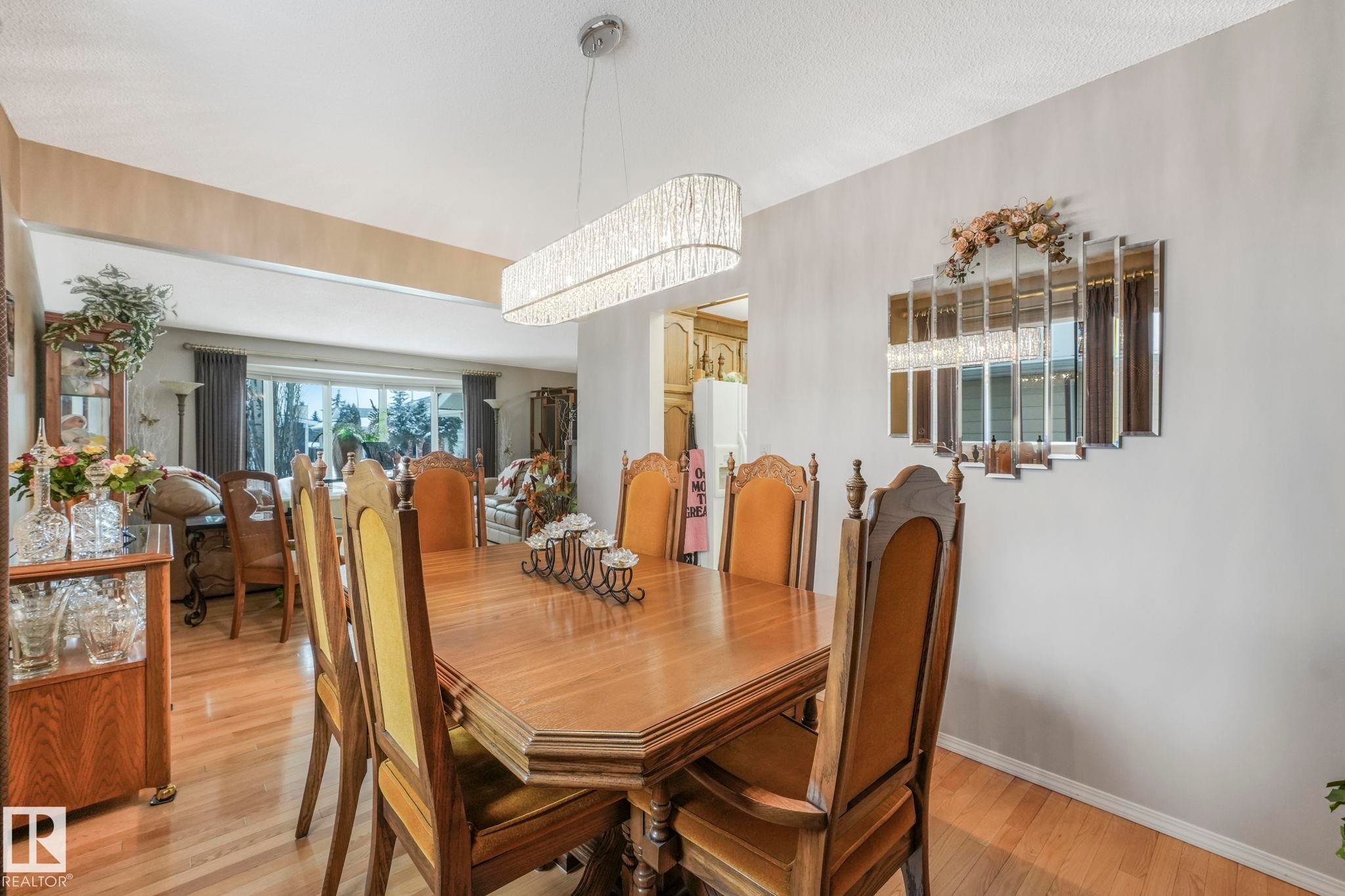 Dining room with wood finished floors and suspended lighting - 15909 112 B Street Nw, Edmonton, AB - Indoor Photo Showing Dining Room