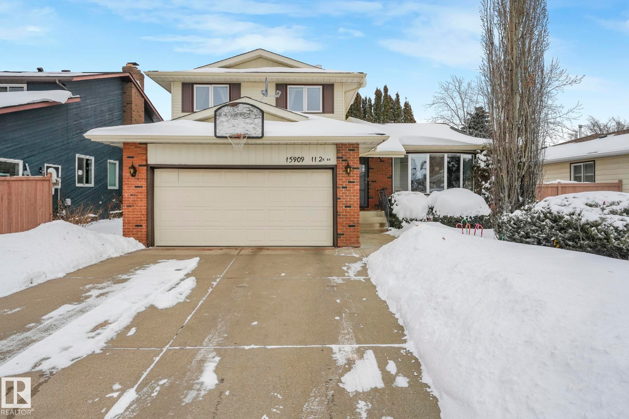 Traditional-style house featuring brick siding, concrete driveway, and an attached garage - 15909 112 B Street Nw, Edmonton, AB - Outdoor With Facade