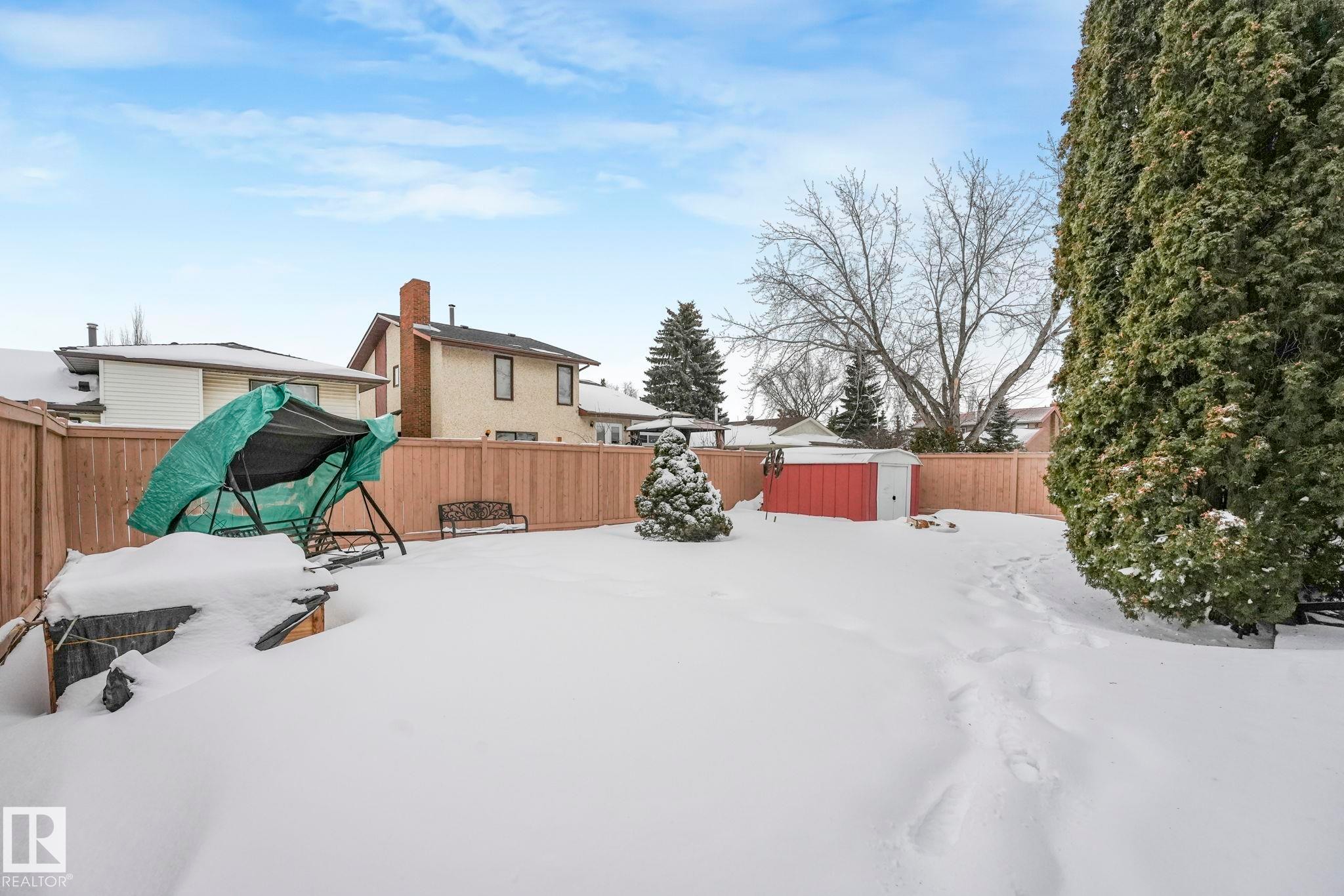 Yard layered in snow with a shed and a fenced backyard - 15909 112 B Street Nw, Edmonton, AB - Outdoor