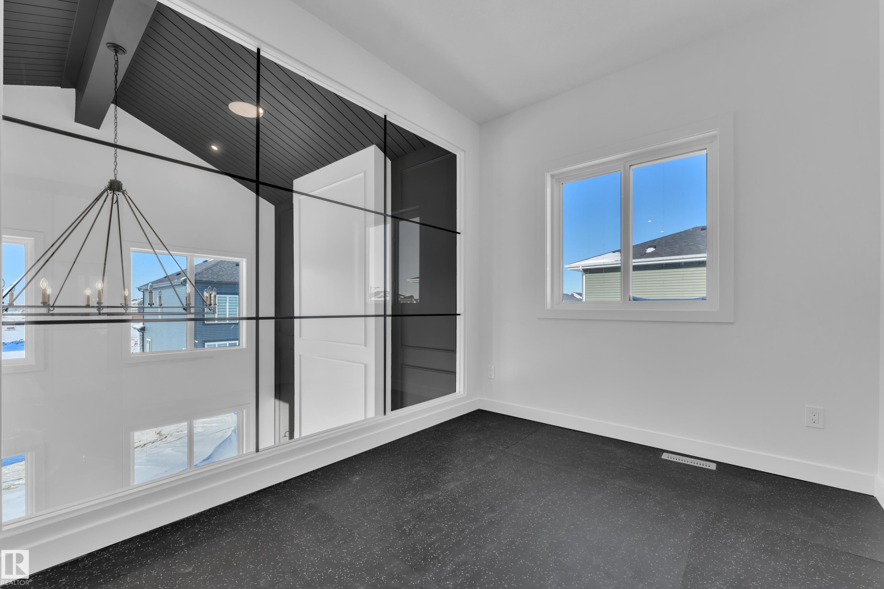 Empty room with a chandelier and lofted ceiling with beams - 95 Eldridge Point(E), St. Albert, AB - Indoor Photo Showing Other Room