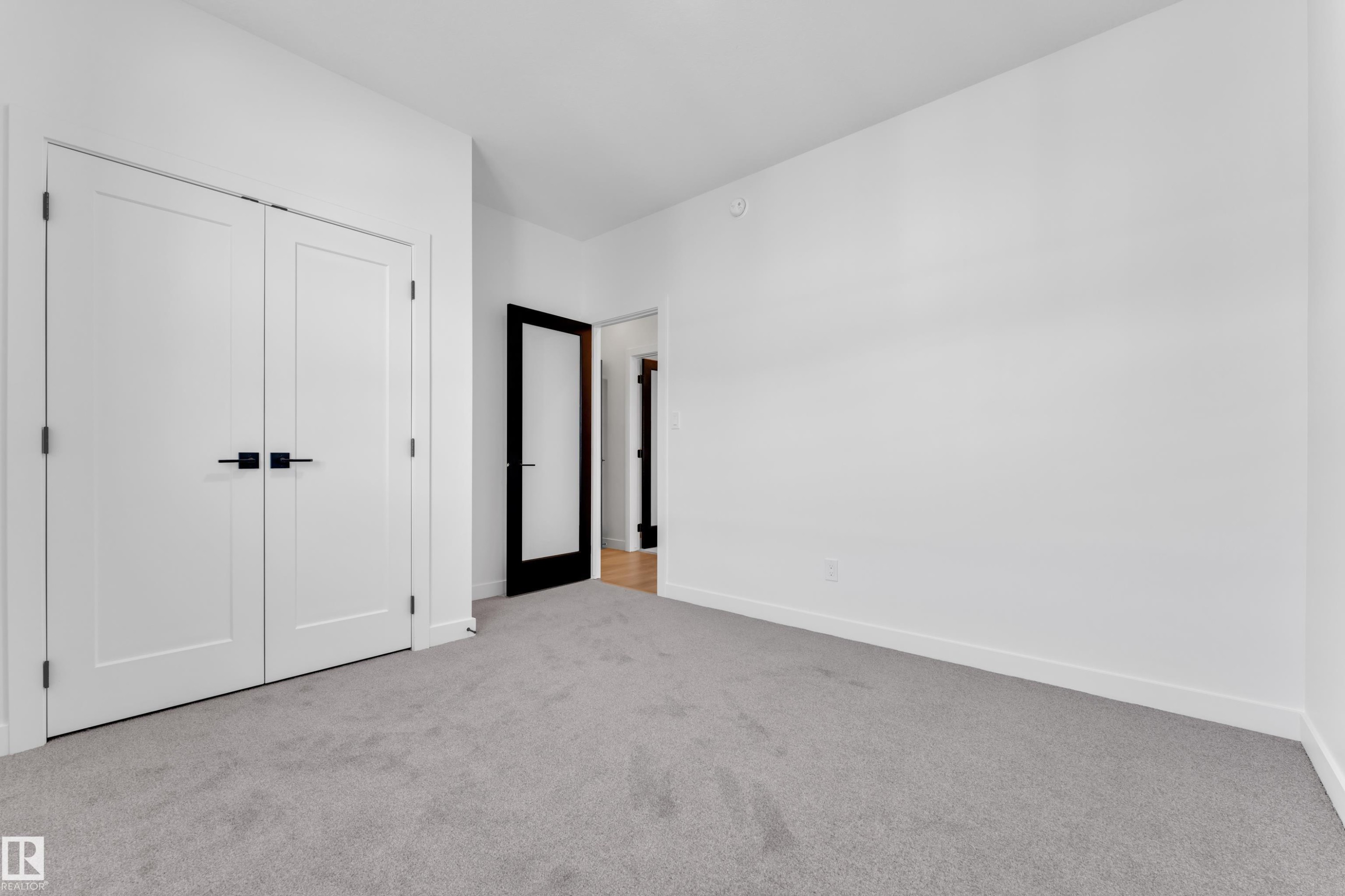 Unfurnished bedroom featuring light colored carpet and a closet - 95 Eldridge Point(E), St. Albert, AB - Indoor Photo Showing Other Room