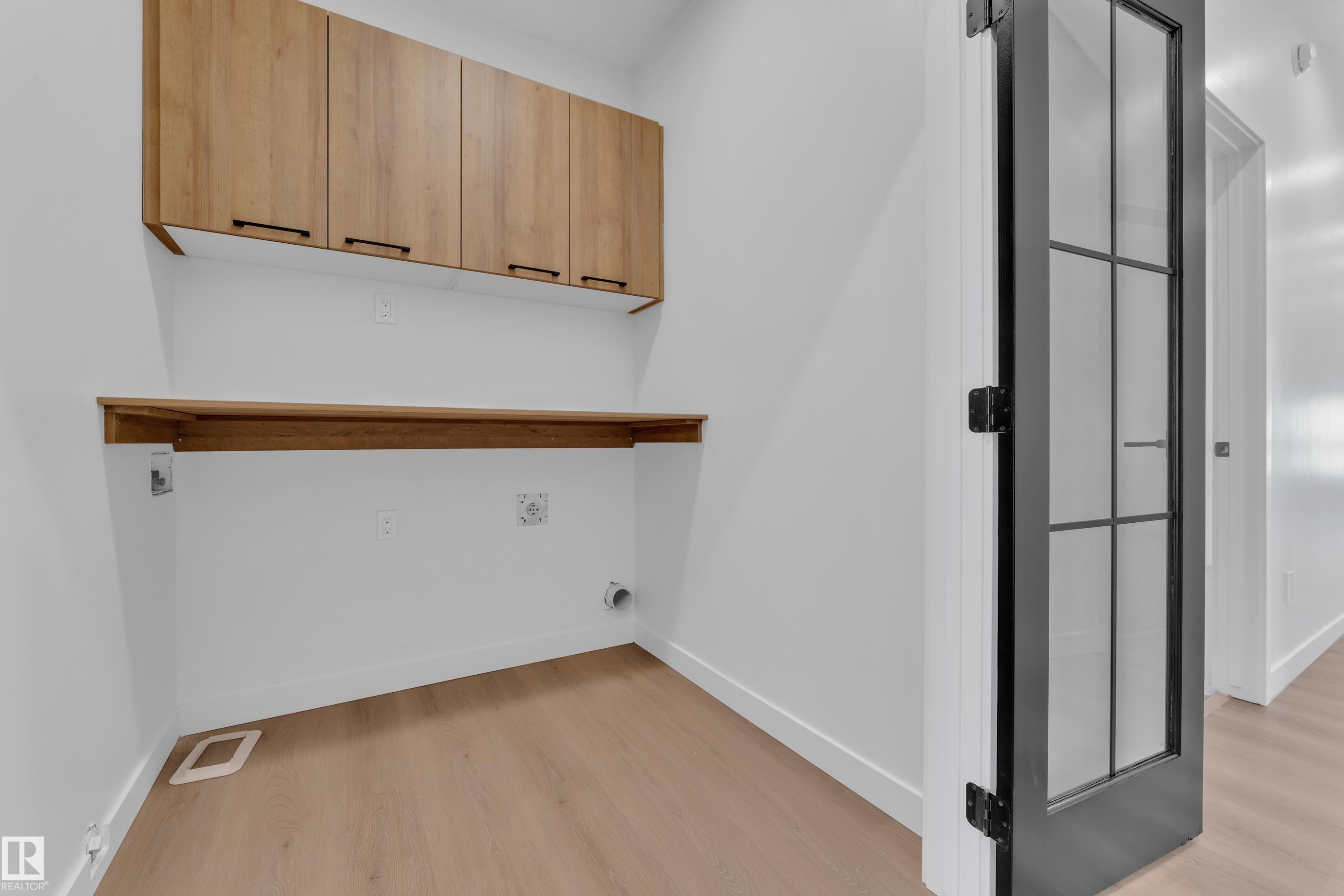 Laundry room with light wood-style floors and cabinet space - 95 Eldridge Point(E), St. Albert, AB - Indoor Photo Showing Other Room