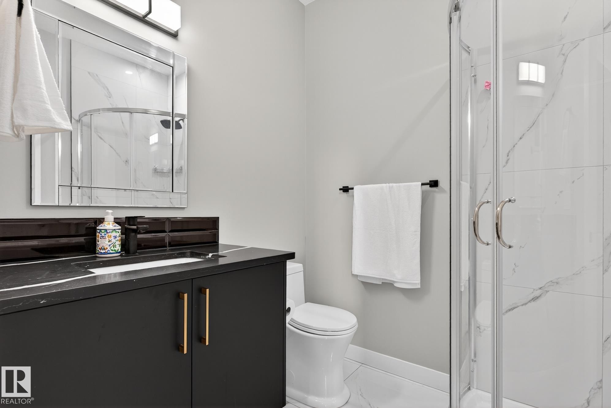 Full bathroom with vanity, a marble finish shower, and marble finish floors - 1027 150 Avenue, Edmonton, AB - Indoor Photo Showing Bathroom