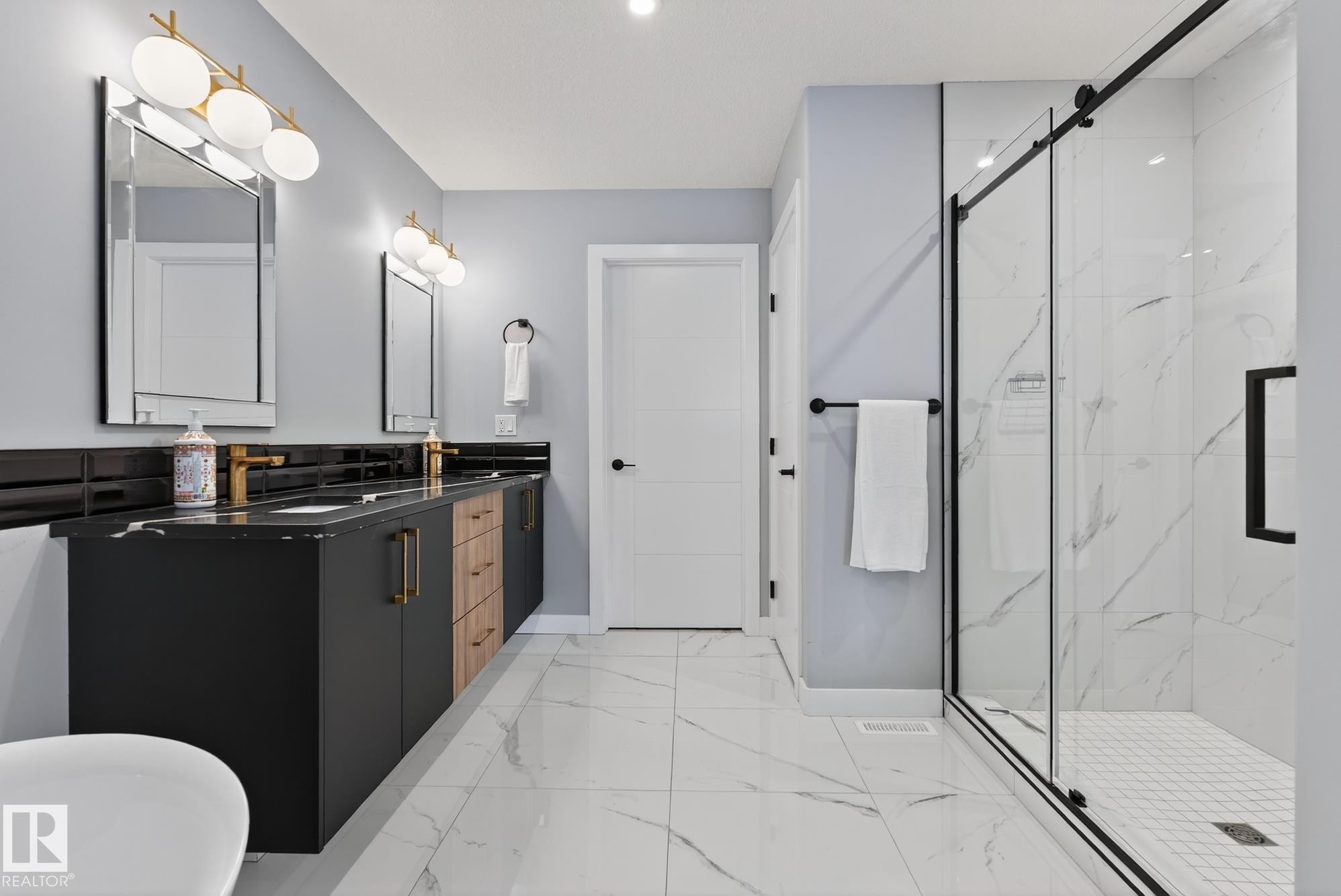 Full bathroom with double vanity, a marble finish shower, and light marble finish flooring - 1027 150 Avenue, Edmonton, AB - Indoor Photo Showing Bathroom