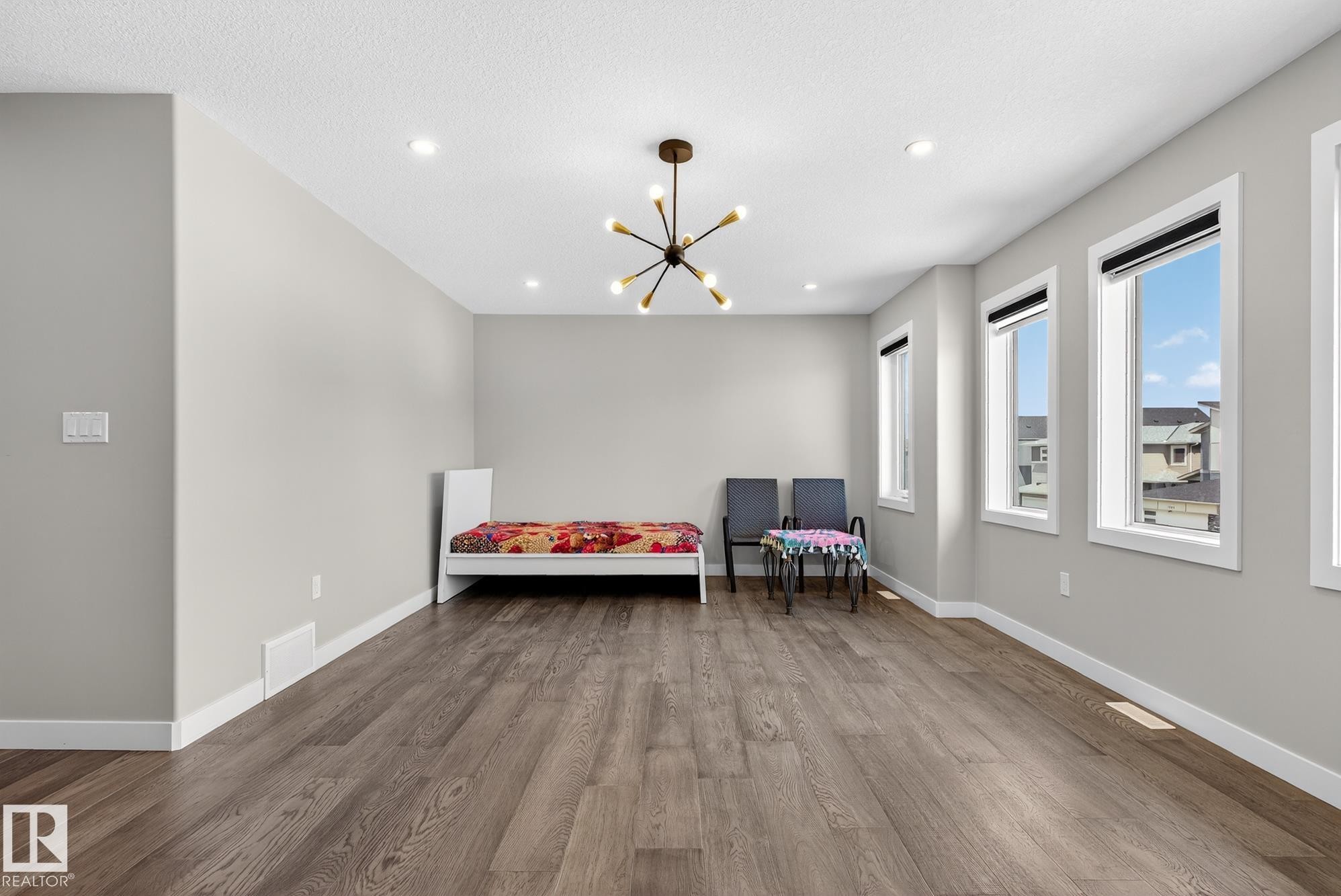 Sitting room with wood finished floors and suspended lighting - 1027 150 Avenue, Edmonton, AB - Indoor
