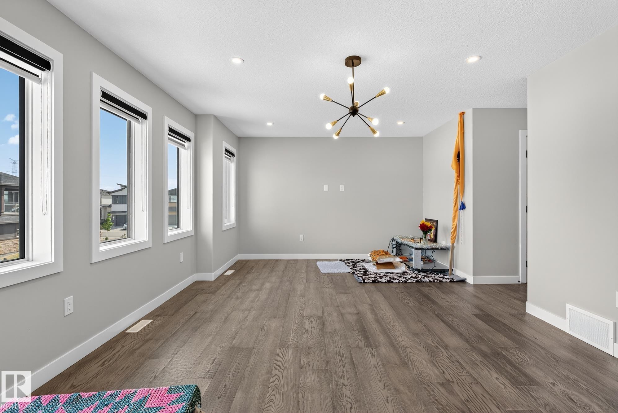 Unfurnished dining area featuring a chandelier and dark wood-style floors - 1027 150 Avenue, Edmonton, AB - Indoor Photo Showing Other Room