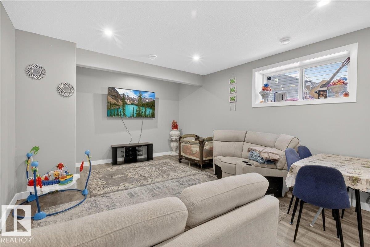 Bedroom featuring a crib, light wood-style floors, a textured ceiling, and a walk in closet - 1027 150 Avenue, Edmonton, AB - Indoor