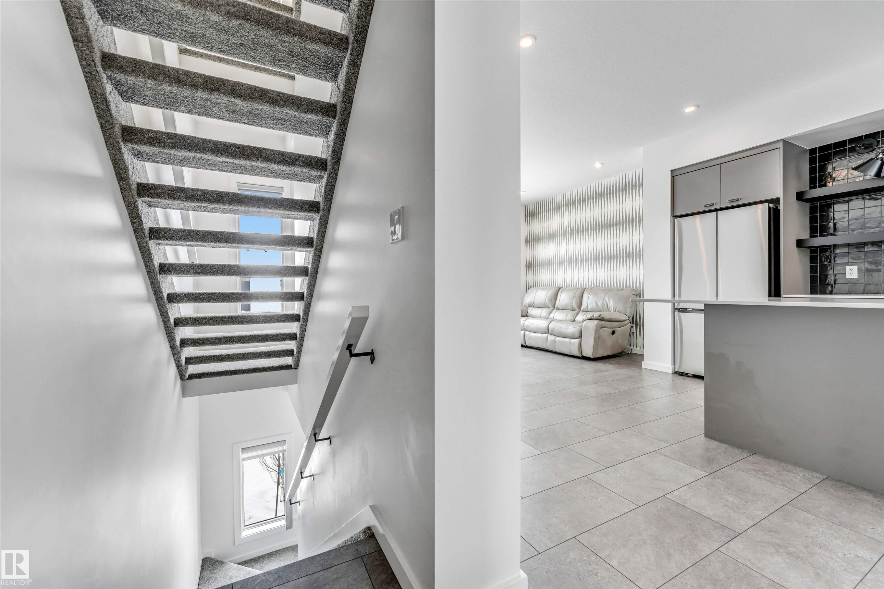 Staircase with tile patterned floors and recessed lighting - 77 5 Rondeau Drive, St. Albert, AB - Indoor Photo Showing Other Room