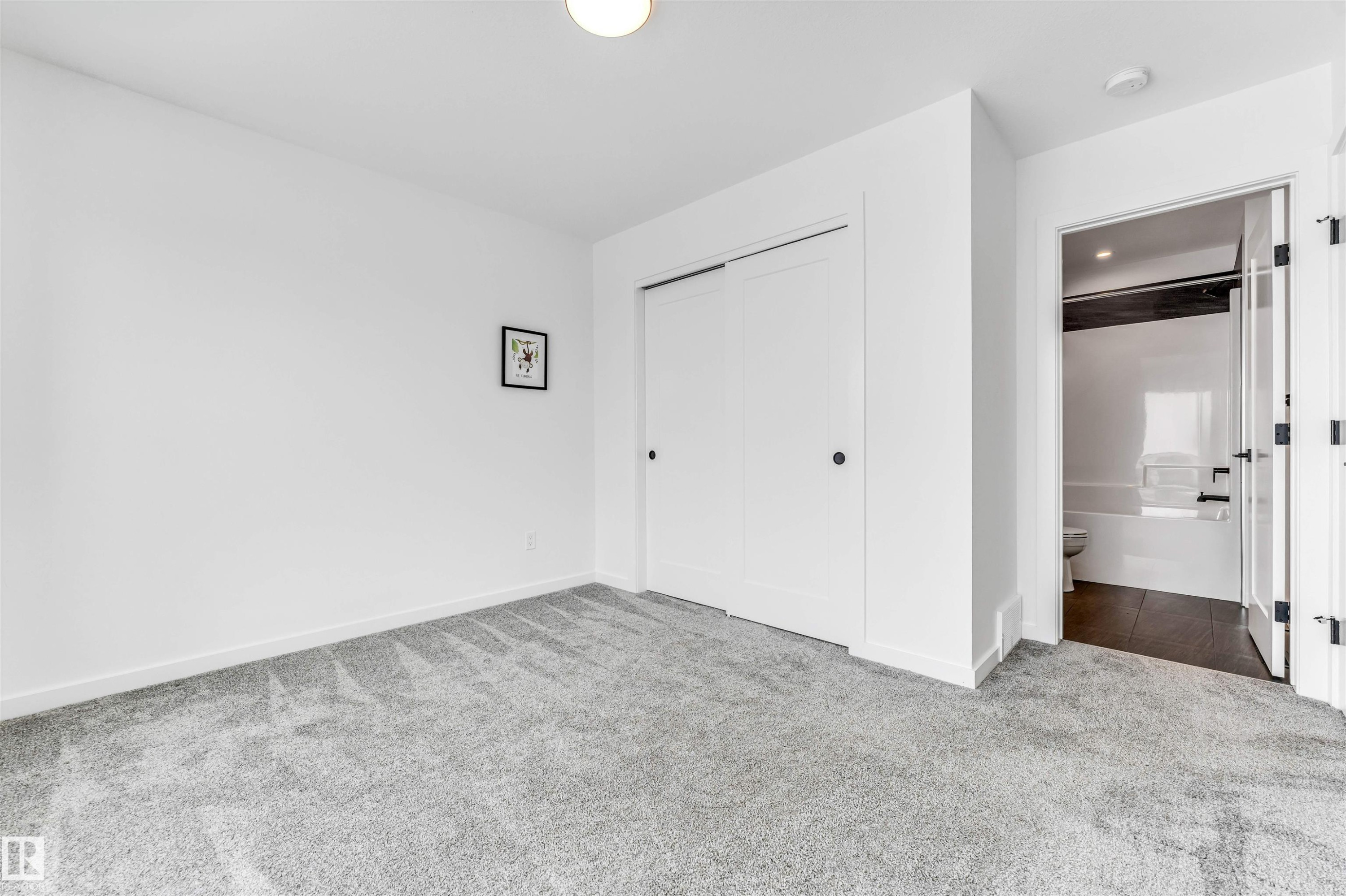 Unfurnished bedroom with carpet flooring and a closet - 77 5 Rondeau Drive, St. Albert, AB - Indoor Photo Showing Other Room