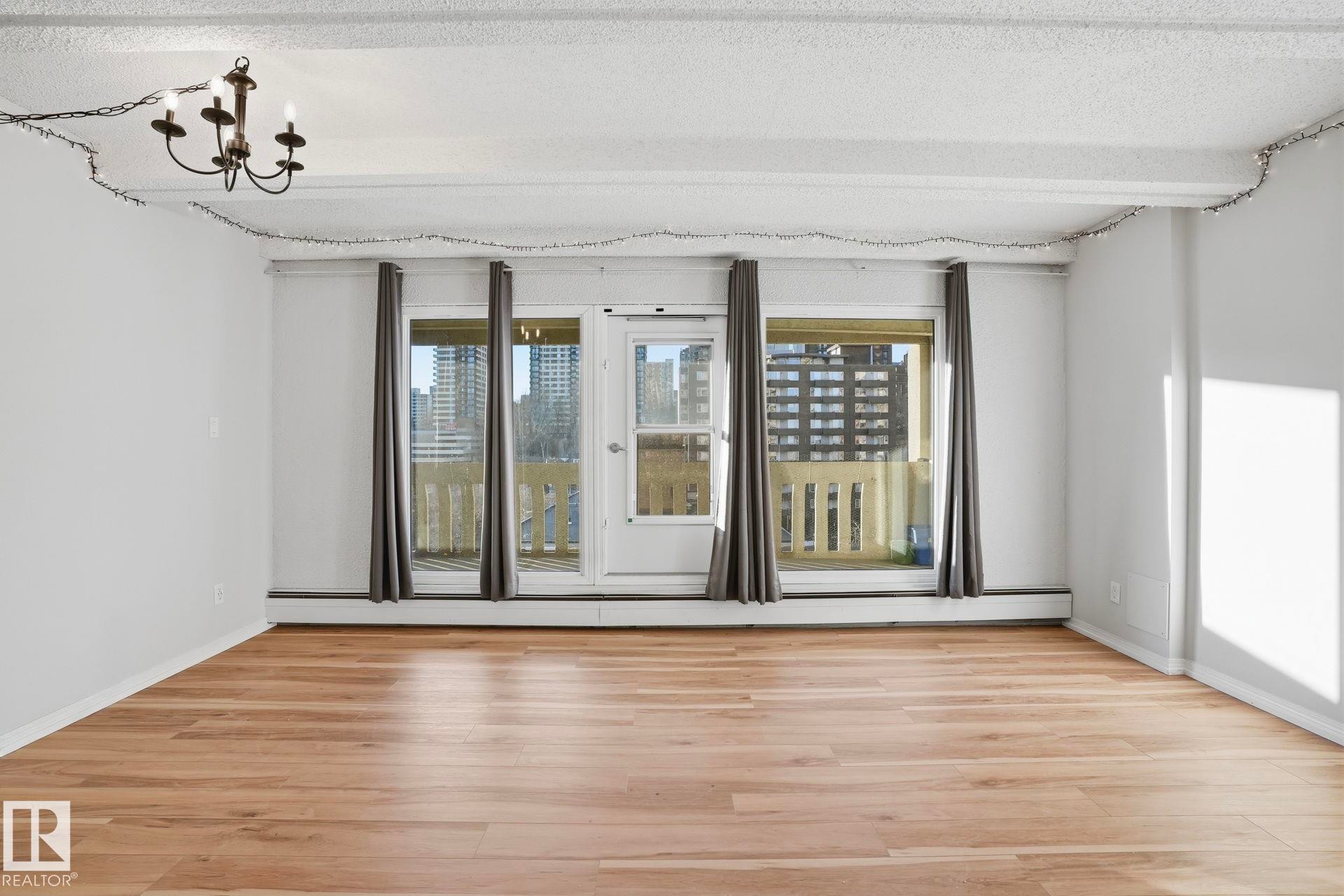 Spare room with light wood finished floors and a textured ceiling - 1103 9918 101 Street, Edmonton, AB - Indoor Photo Showing Other Room