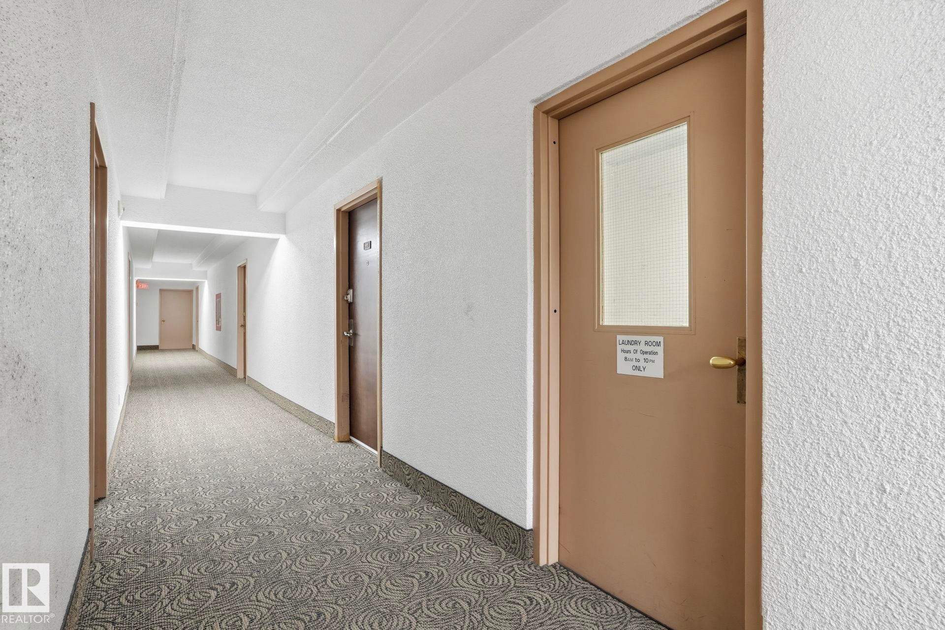 Corridor featuring a textured wall and carpet - 1103 9918 101 Street, Edmonton, AB - Indoor Photo Showing Other Room