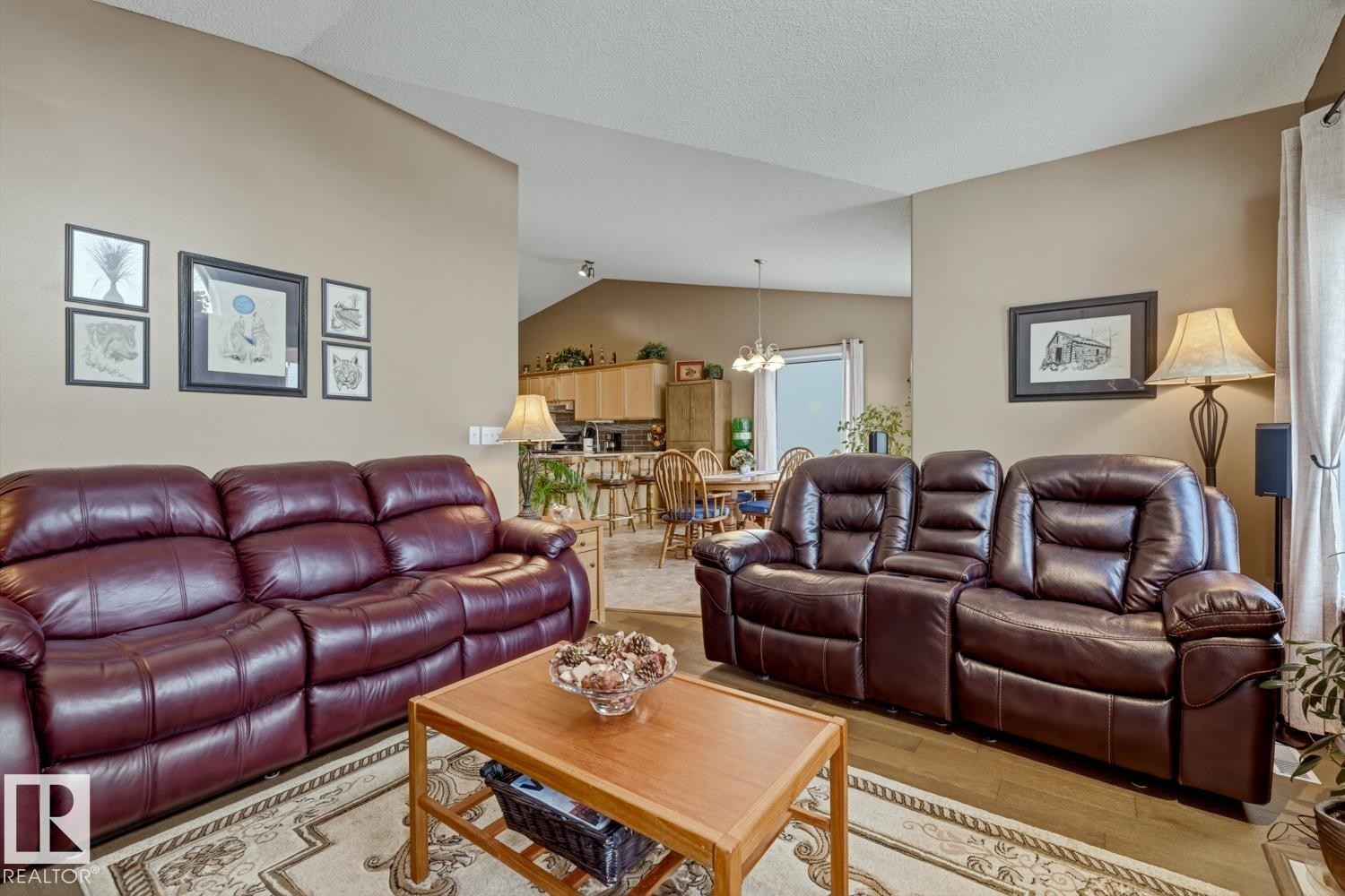 Living area featuring wood finished floors and suspended lighting - 20148 46 Avenue, Edmonton, AB - Indoor Photo Showing Living Room